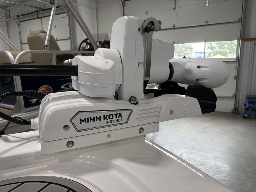 Minn Kota Instinct motor on 2026 Tidewater 2700 CB boat in garage.