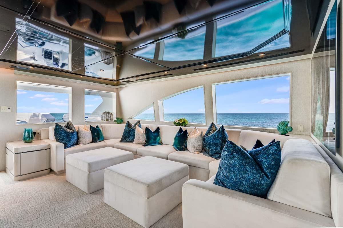 Luxurious 2001 Westship Skylounge interior with ocean view, featuring plush seating and elegant decor.