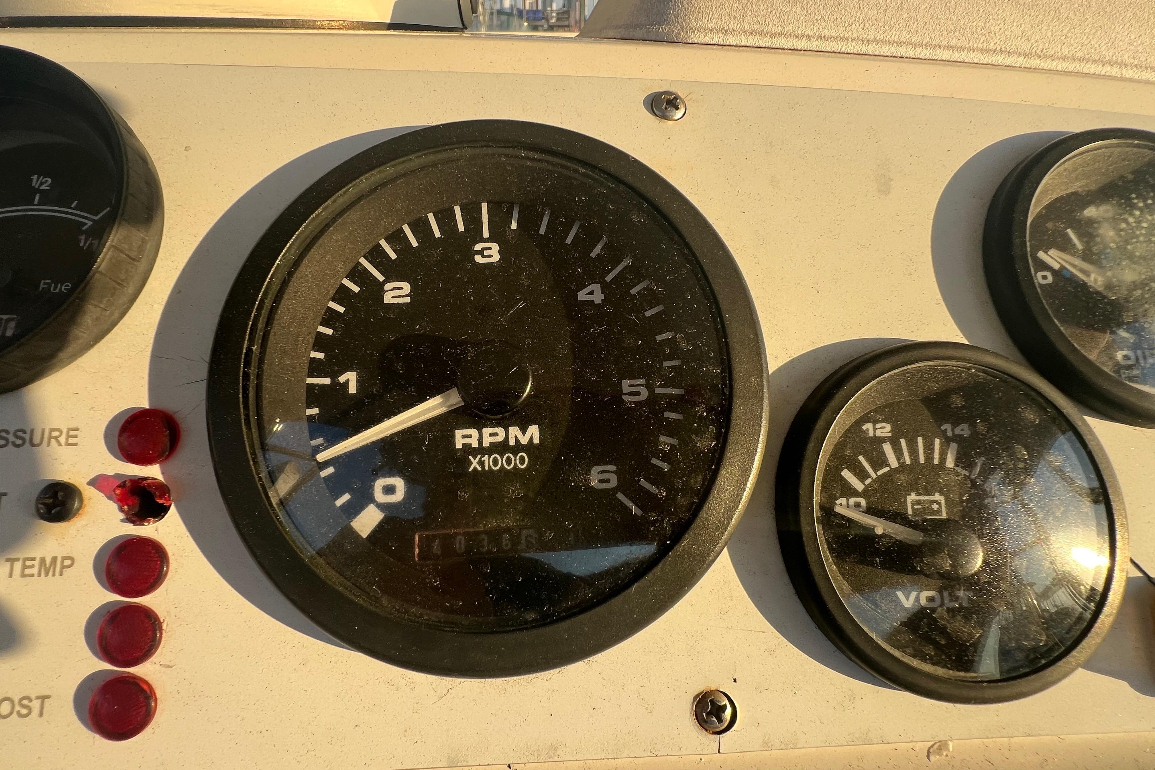 Close-up of 2002 Out Island 38 Express Fisherman dashboard gauges, showing RPM and voltage.