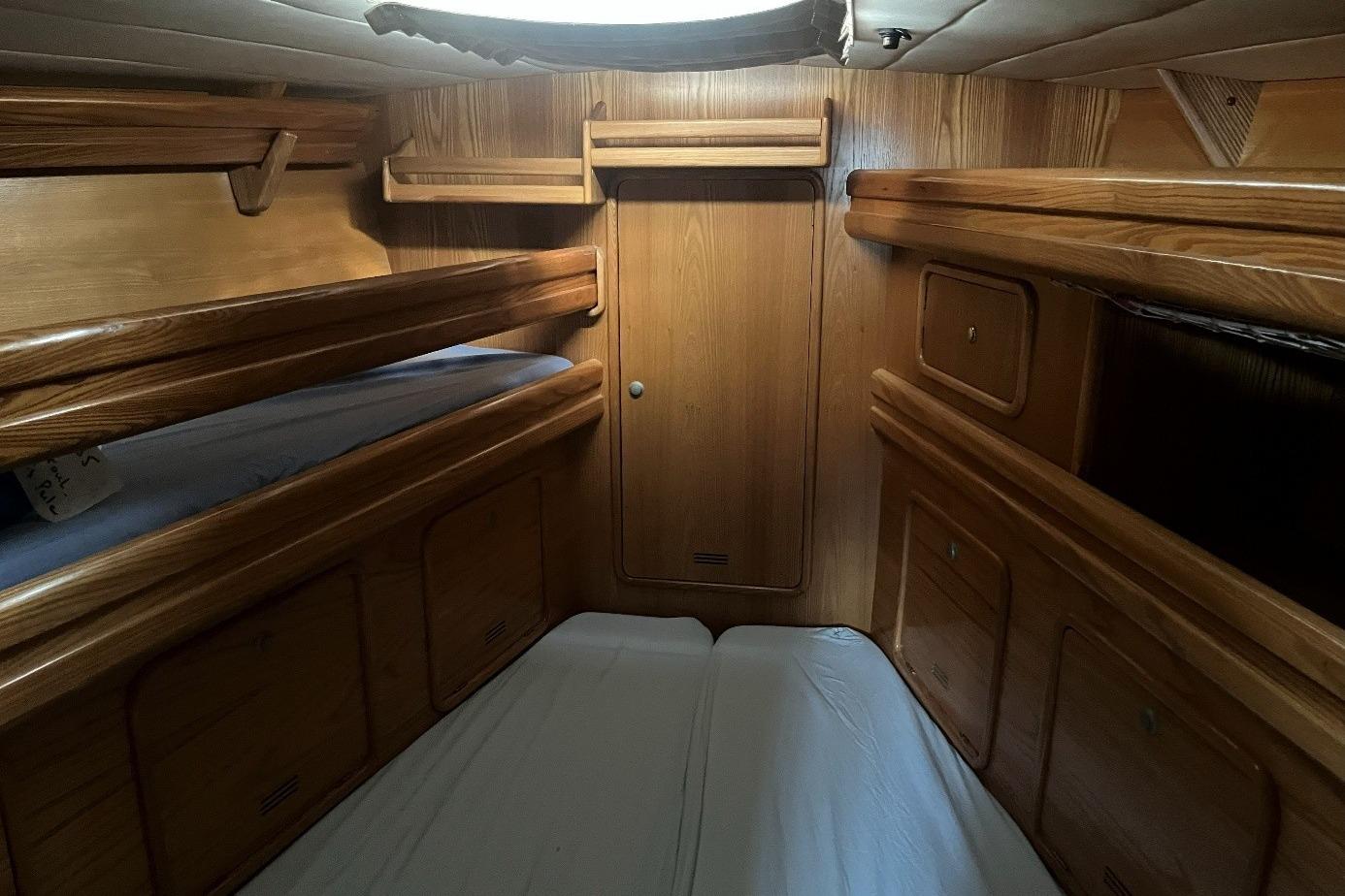 Interior cabin of 2001 Alubat OVNI 435 yacht with wooden finish and bunk beds.