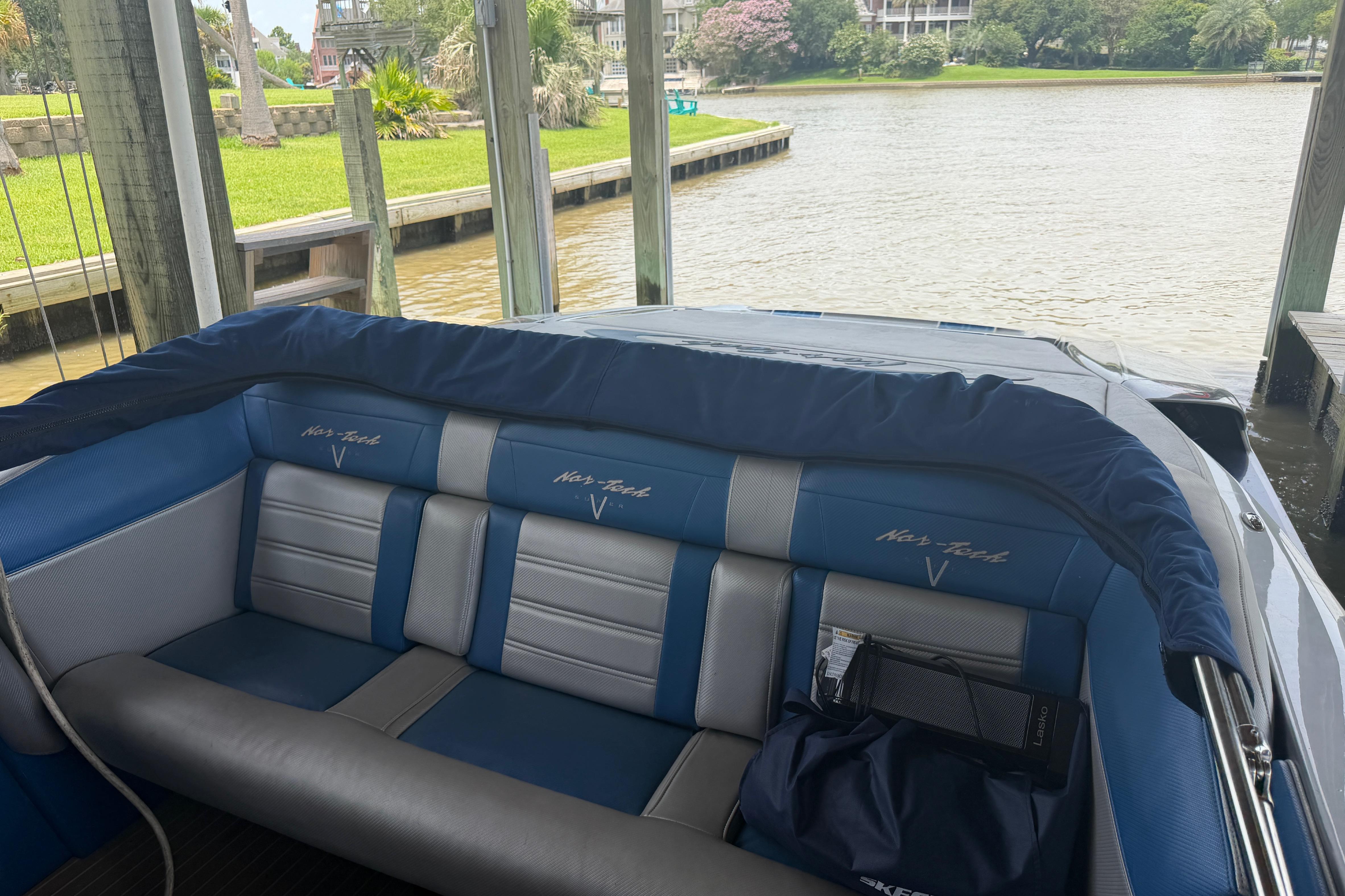 2013 Nor-Tech 477 SPX Vee Bottom boat interior with blue and gray seating by the water.