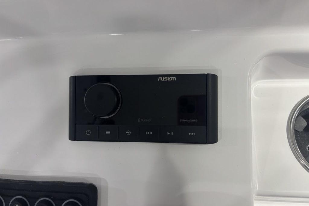 Fusion audio system on 2026 Sportsman Open 252 Center Console boat dashboard.