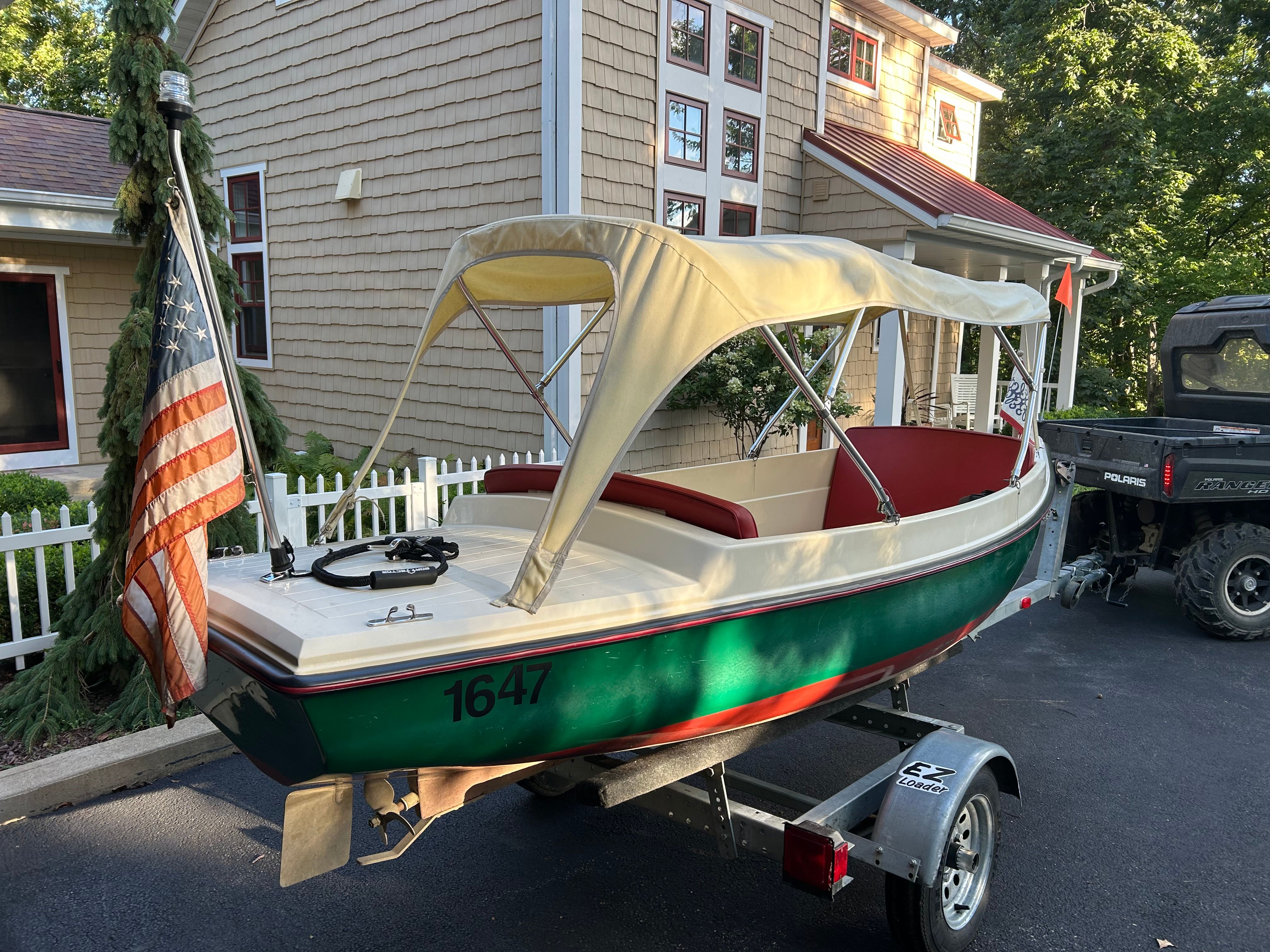 1995 Elco Launchboat on trailer parked in front of a house.