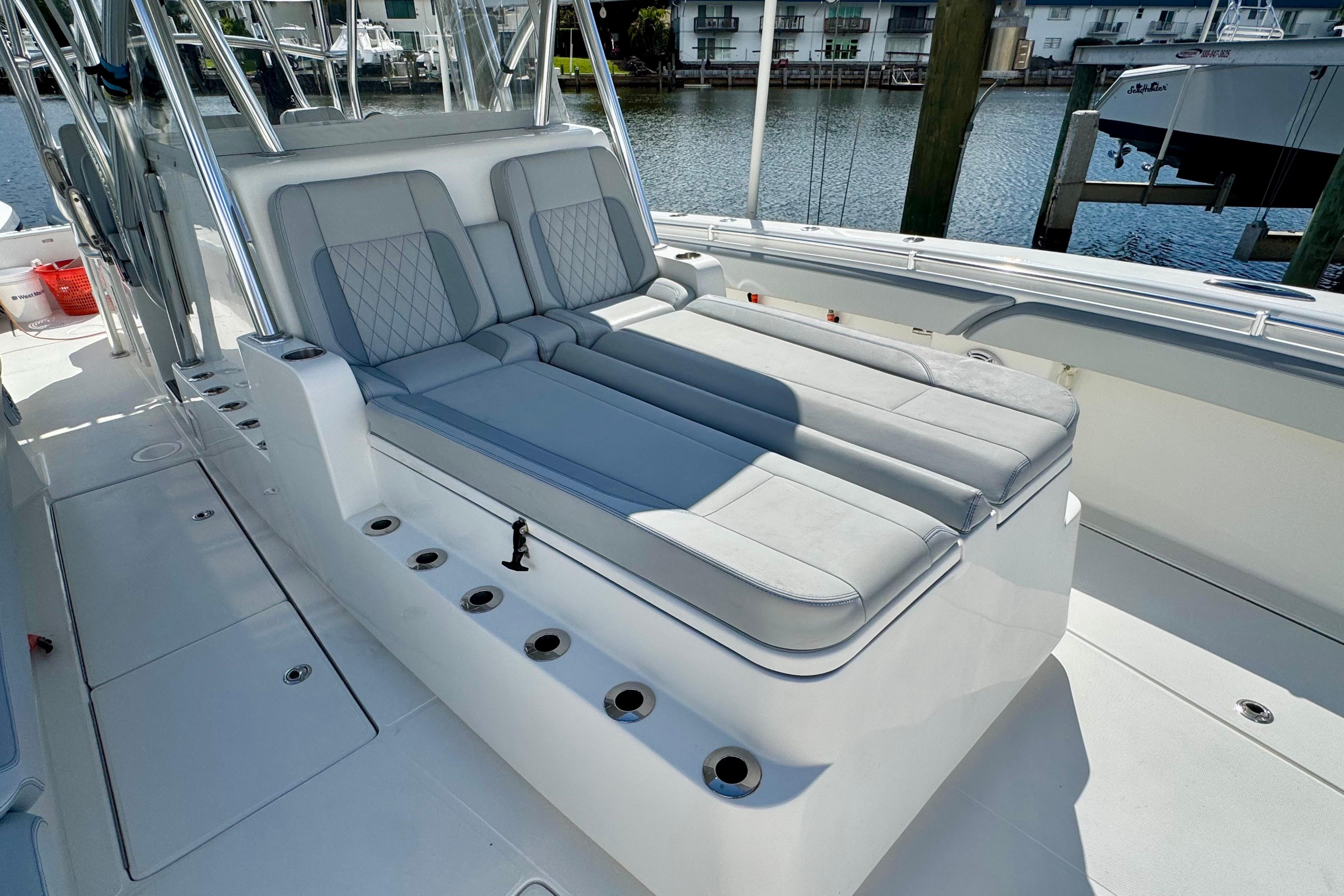 2021 SeaHunter 41 CTS boat with luxurious seating and rod holders, docked by the water.