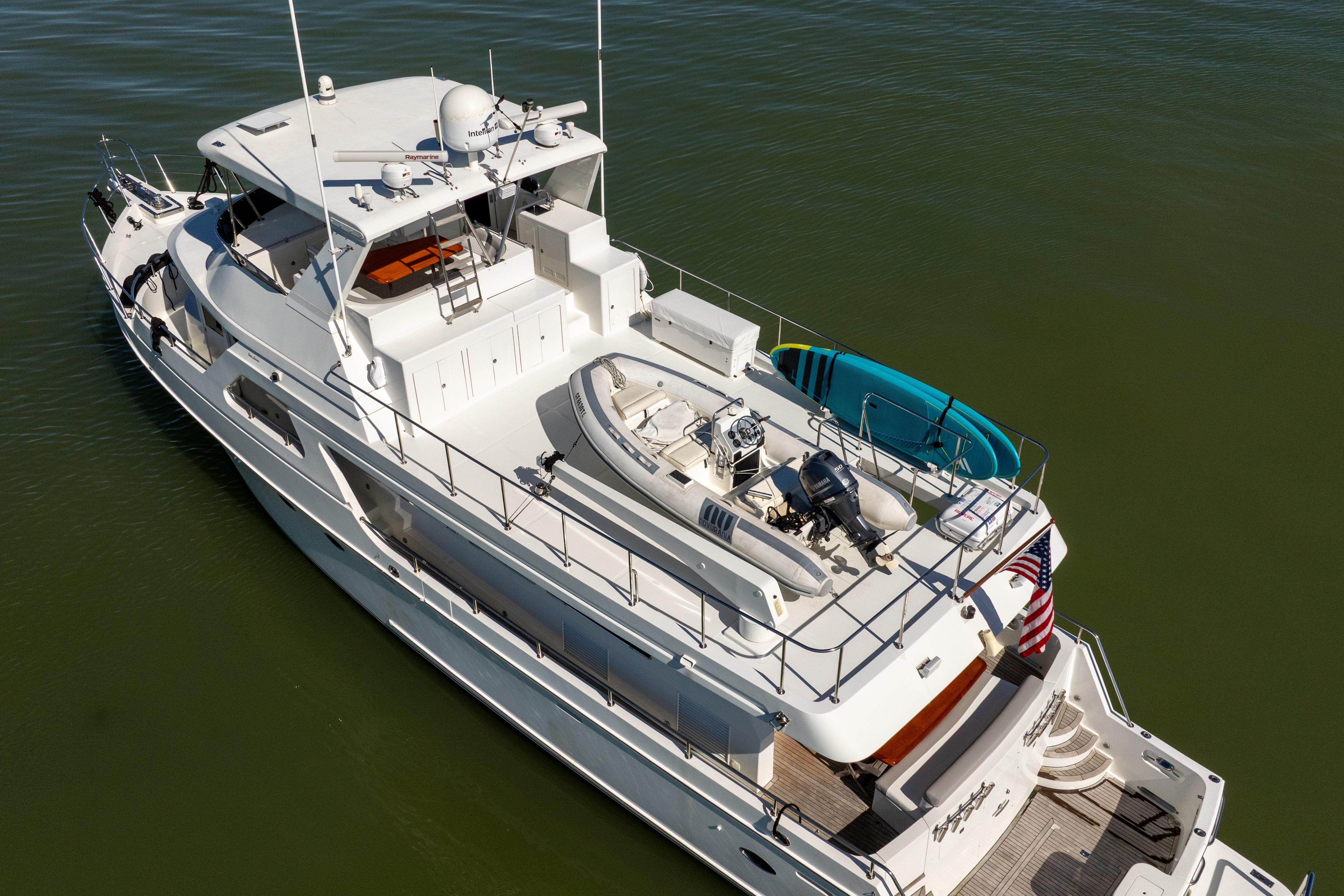2003 Ocean Alexander 700 Classicco yacht with tender and paddleboard on deck.