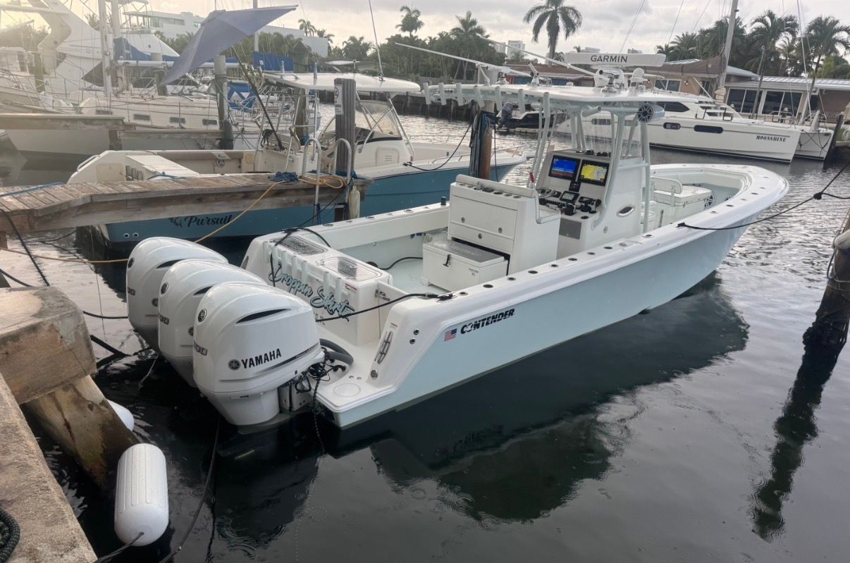 2019 Contender 35 ST boat with Yamaha engines docked at marina.