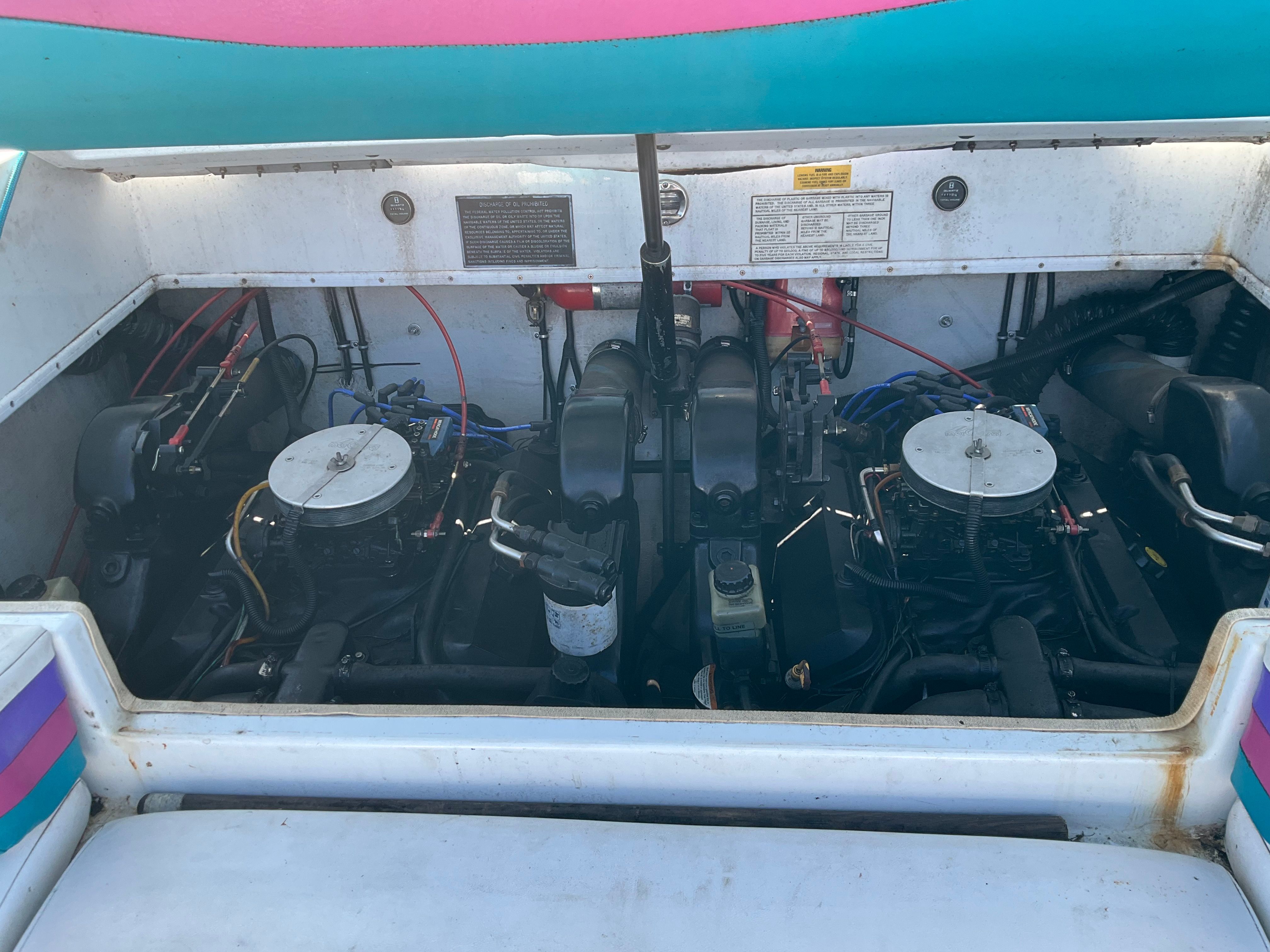 Engine compartment of a 1995 Baja Caliber boat with two engines.