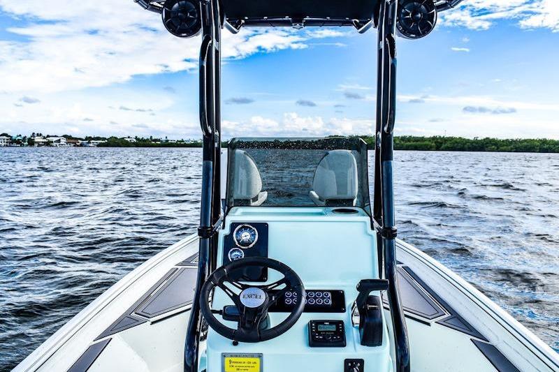 2026 Excel 230 Bay Pro Elite boat on open water, featuring modern steering console.