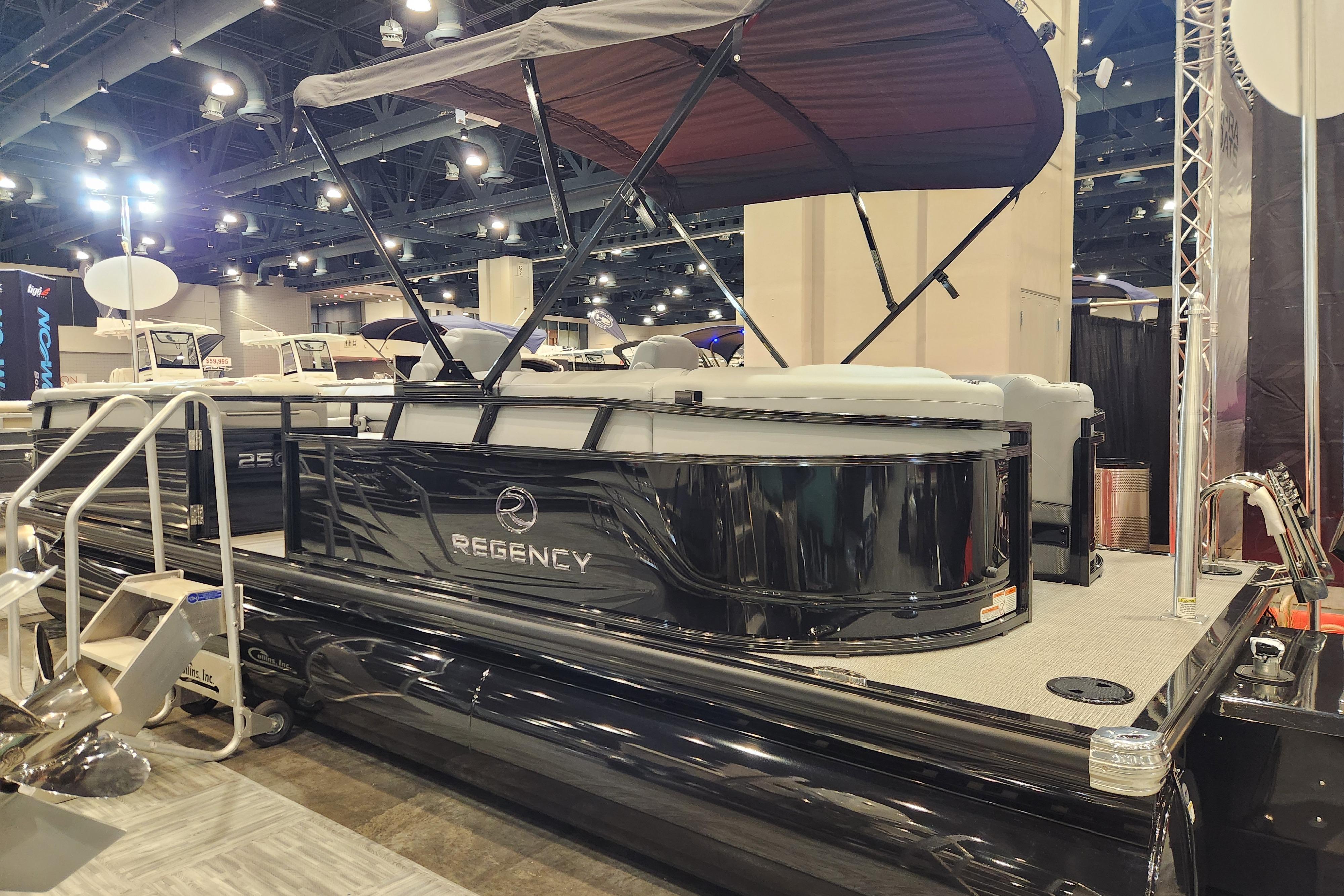 2025 Regency 250 LE3 pontoon boat displayed indoors with canopy and seating.