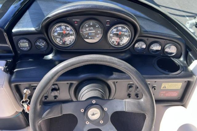 Dashboard of a 1996 MasterCraft ProStar 190 boat with steering wheel and gauges.