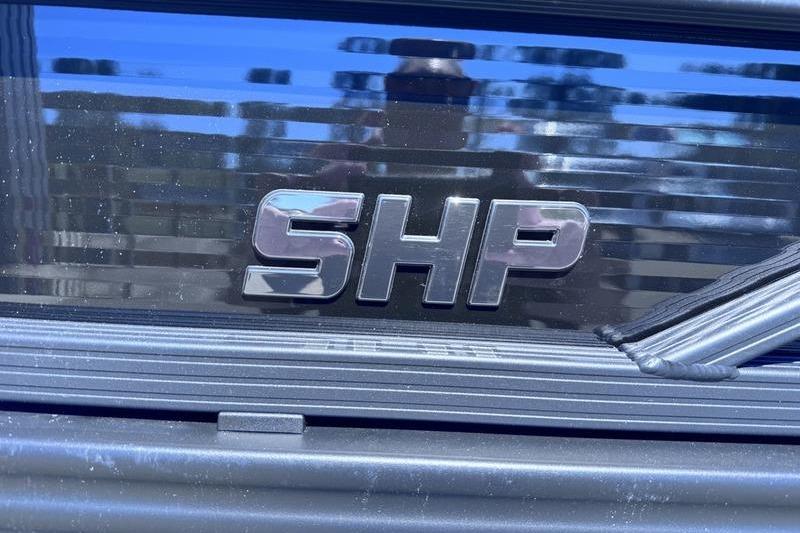 Close-up of 2027 Manitou Aurora 23 RF SHP logo on a reflective surface.