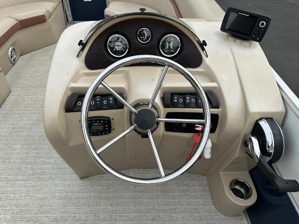Helm of a 2018 South Bay S224CR with steering wheel and gauges.