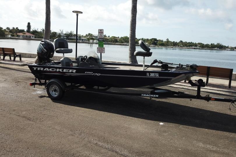 2020 Tracker Pro 170 boat on trailer by waterfront, sunny day.
