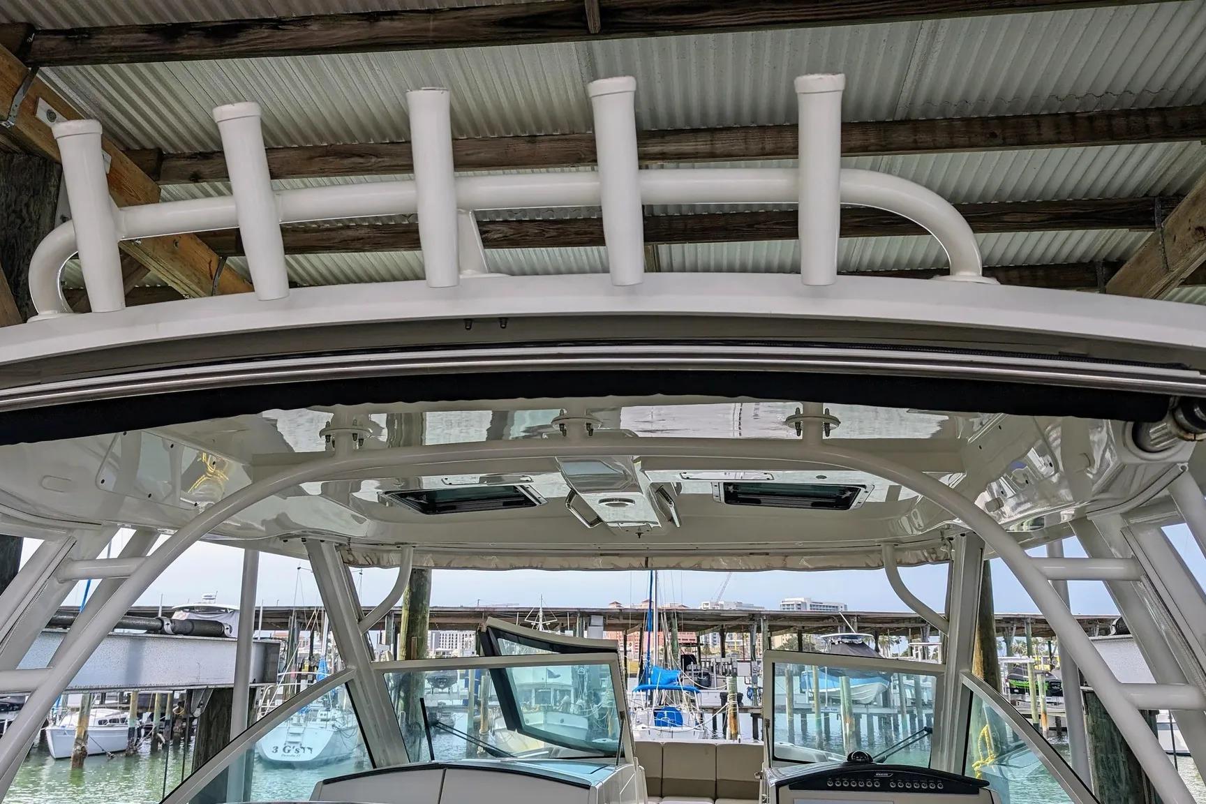 2017 Boston Whaler 320 Vantage boat interior with rod holders and marina view.