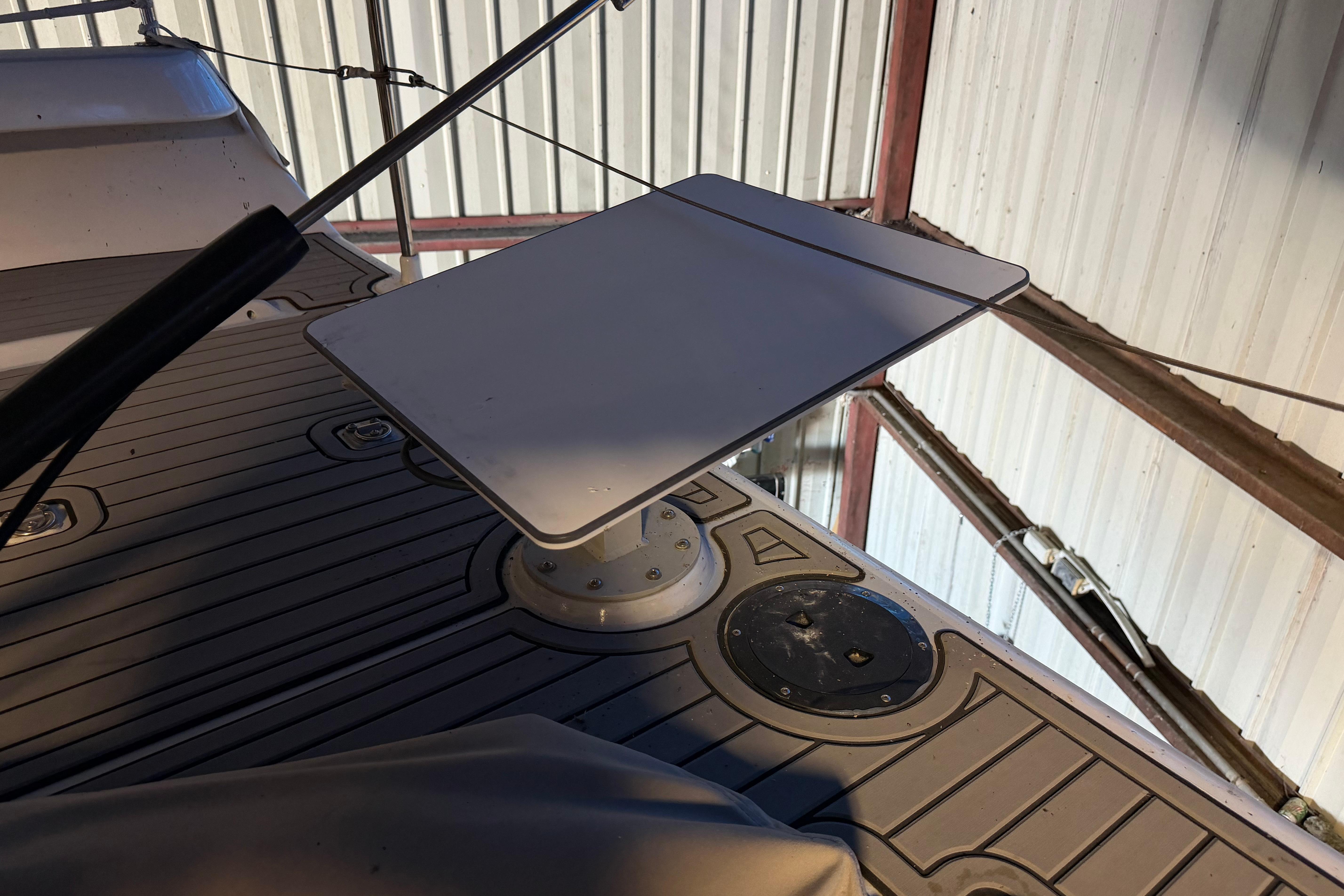 Andrews 63 boat deck with mounted table in a covered storage area.