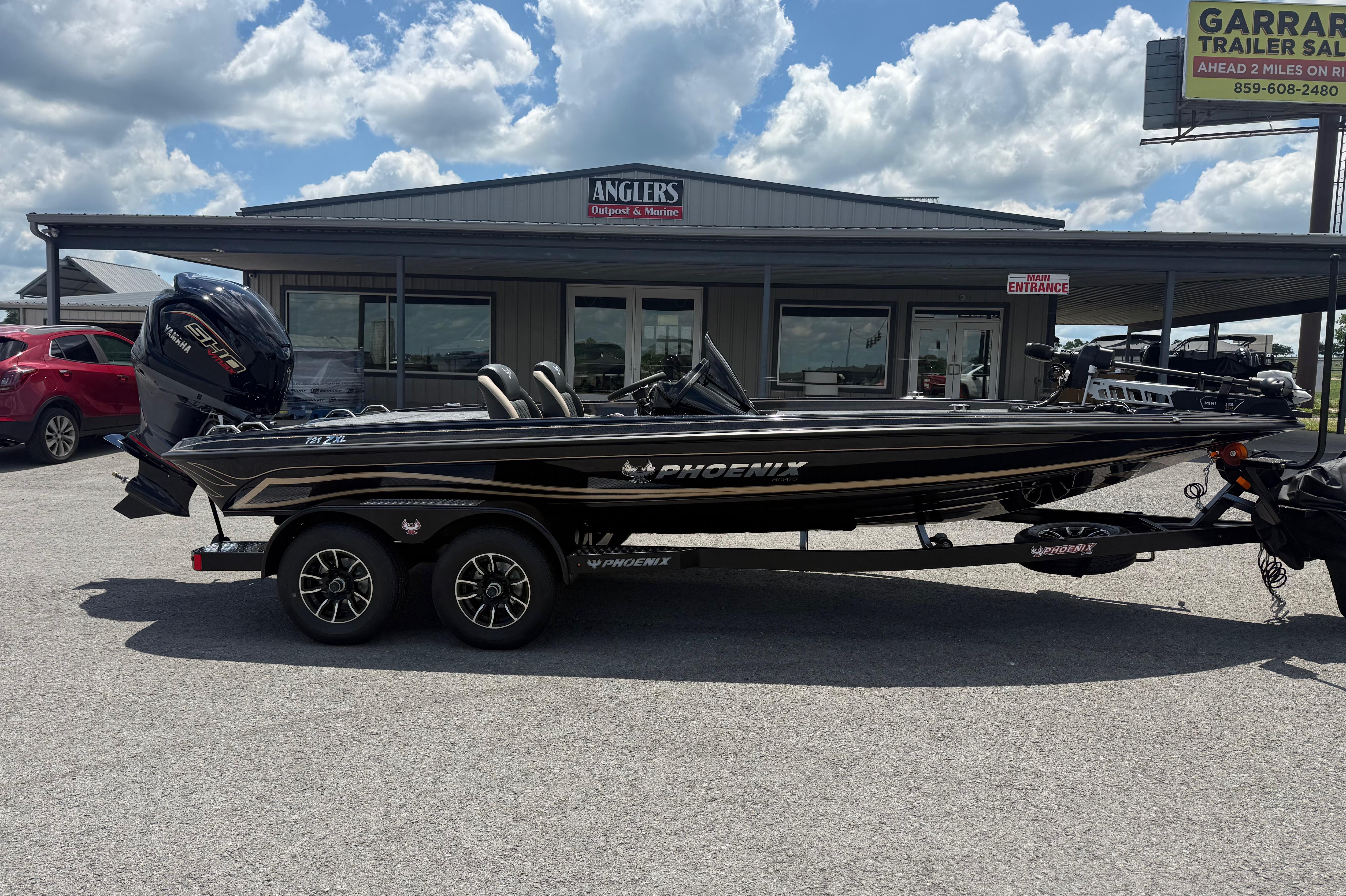 2027 Phoenix 721 ZXL boat parked outside dealership under cloudy sky.