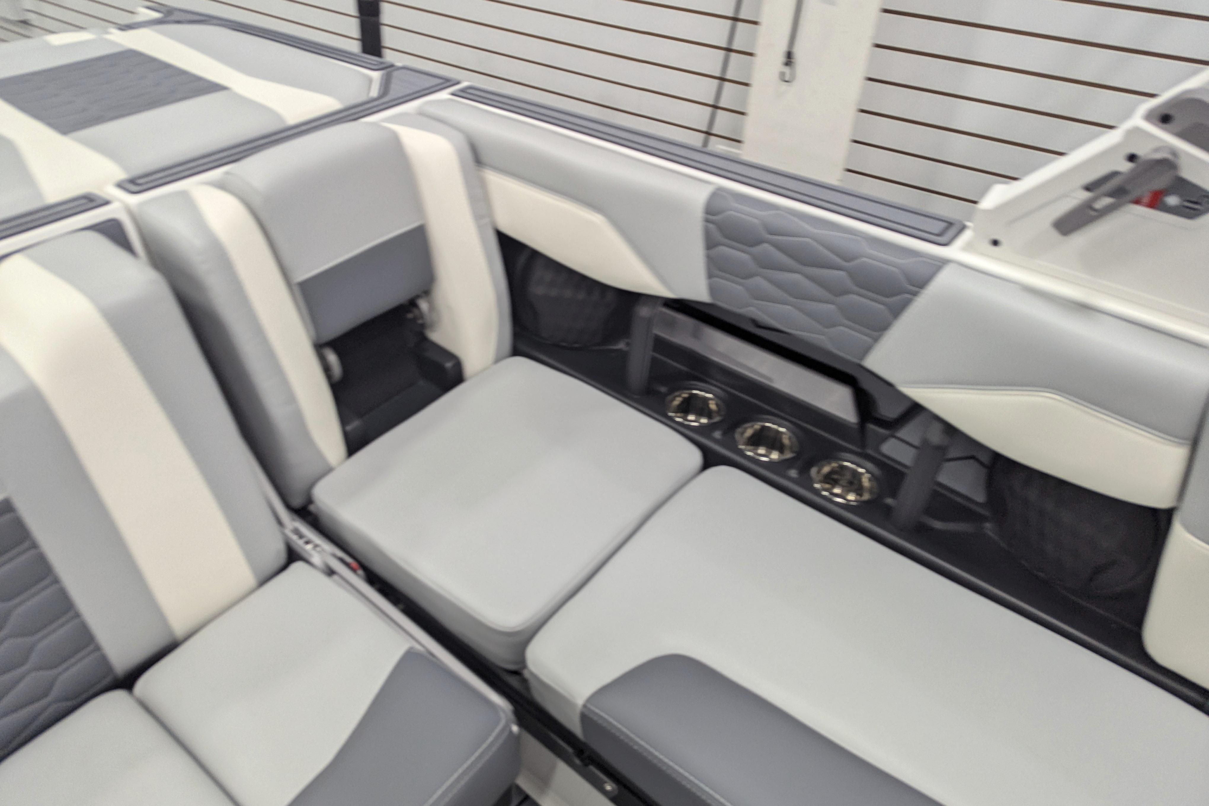 2025 Malibu Wakesetter 24 MXZ interior with gray and white seating, modern design.