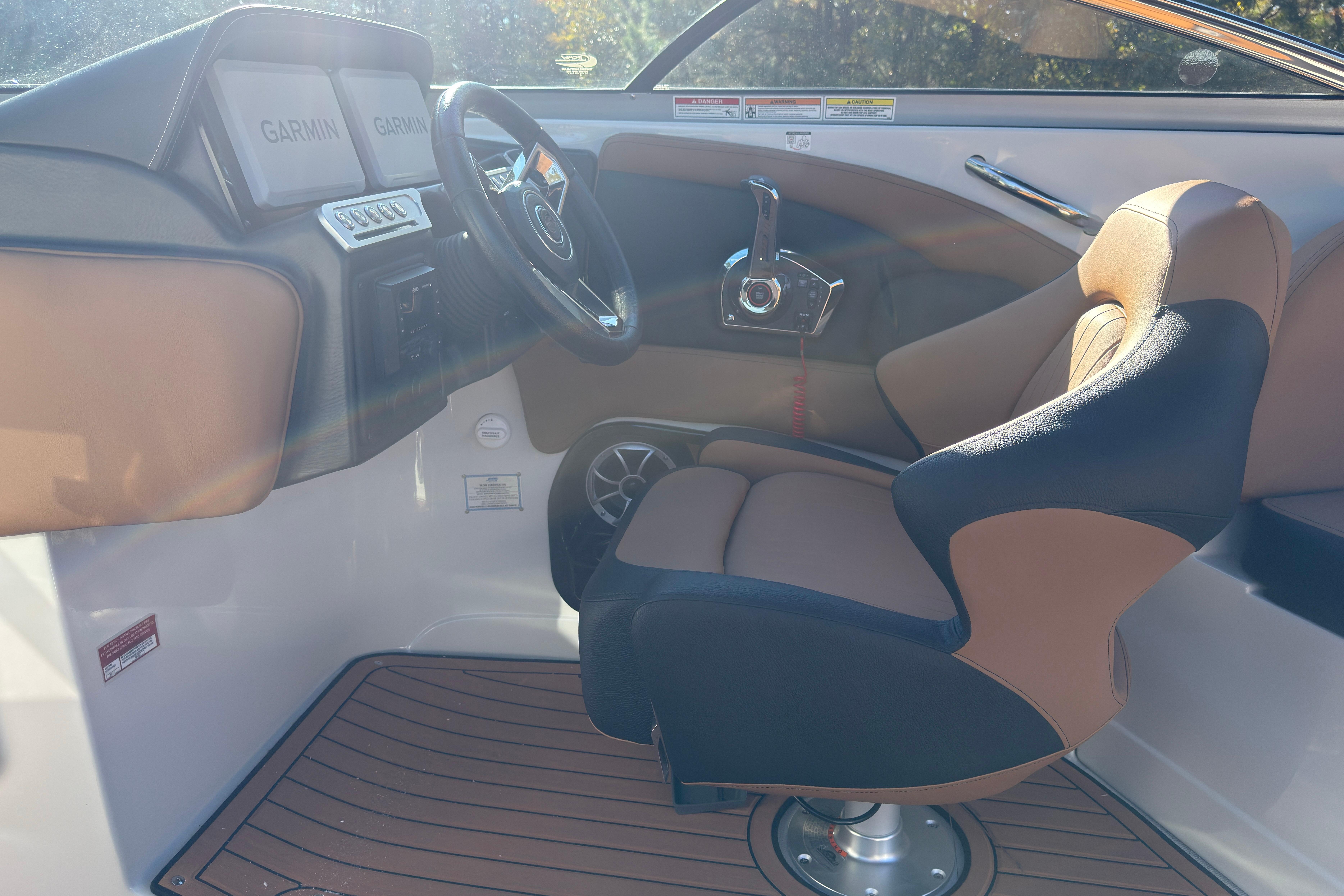 Interior of 2026 Crownline 298 SS boat with Garmin displays and luxury seating.