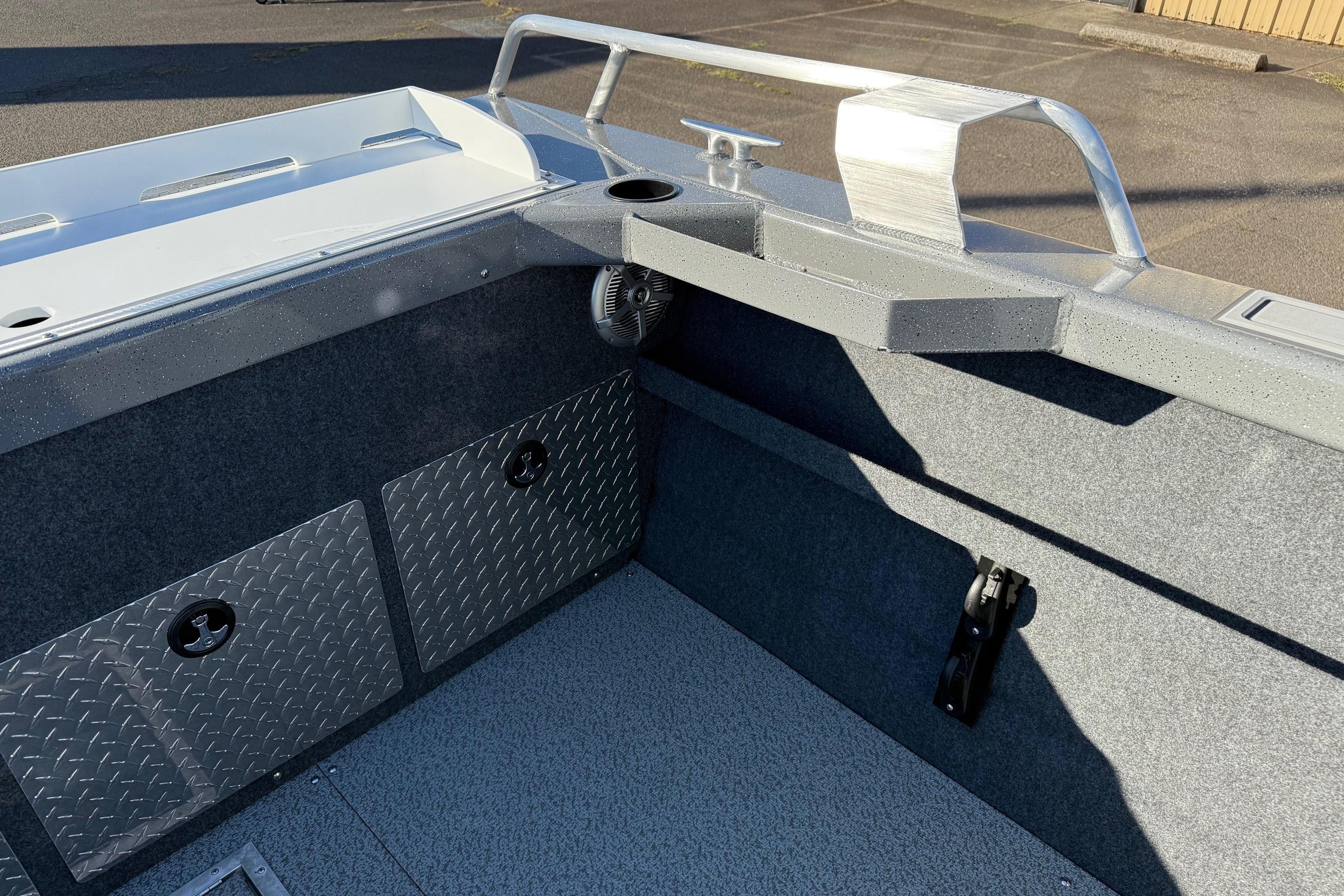 Interior view of 2026 Thunder Jet 200 Luxor boat, featuring storage compartments and metal railings.