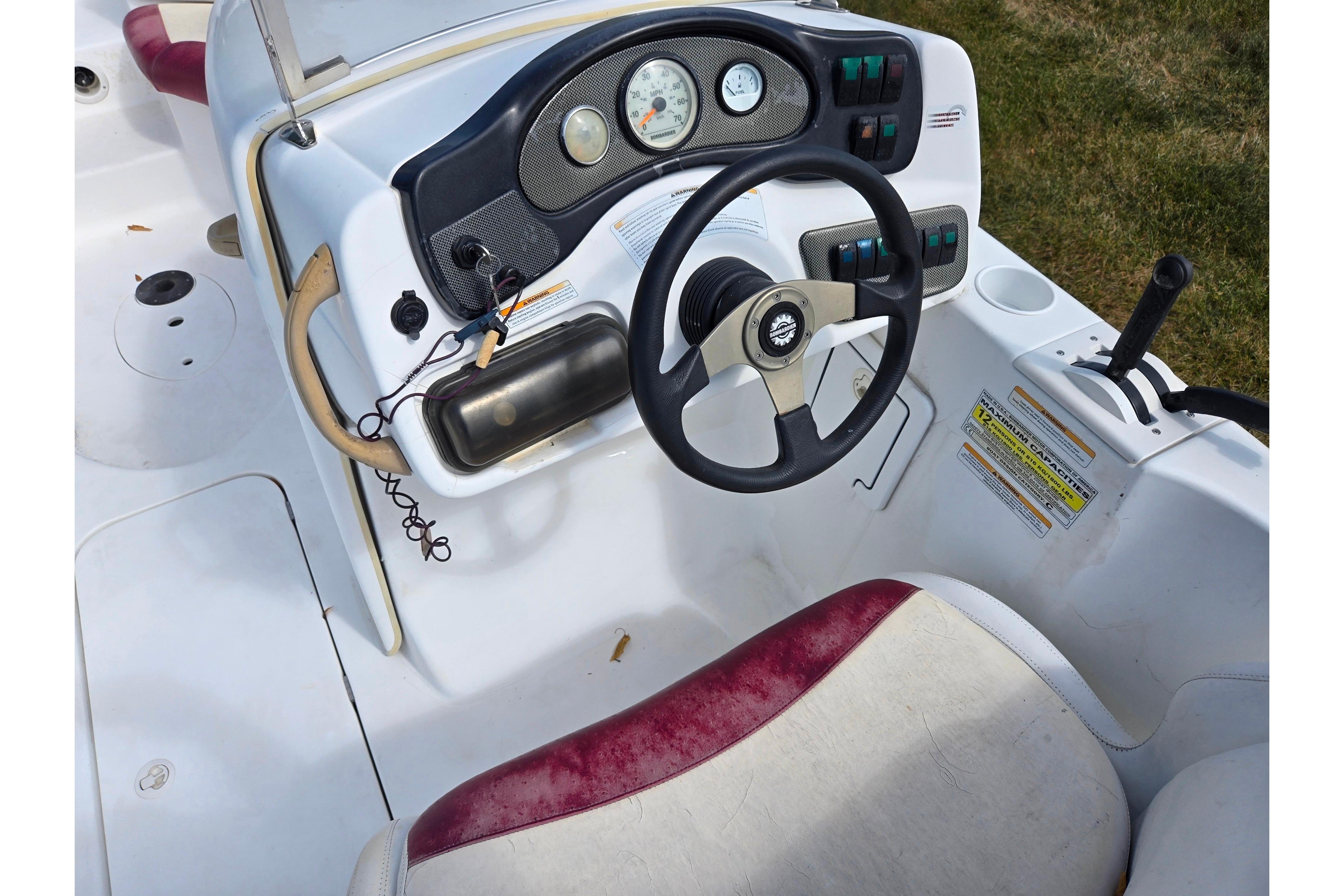 2004 Sea-Doo Islandia boat dashboard with steering wheel and control panel.