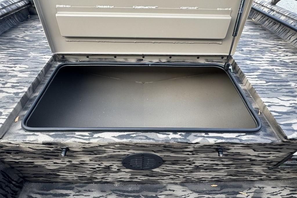 Open storage compartment in 2026 Havoc 1756 boat, featuring camo-patterned interior.