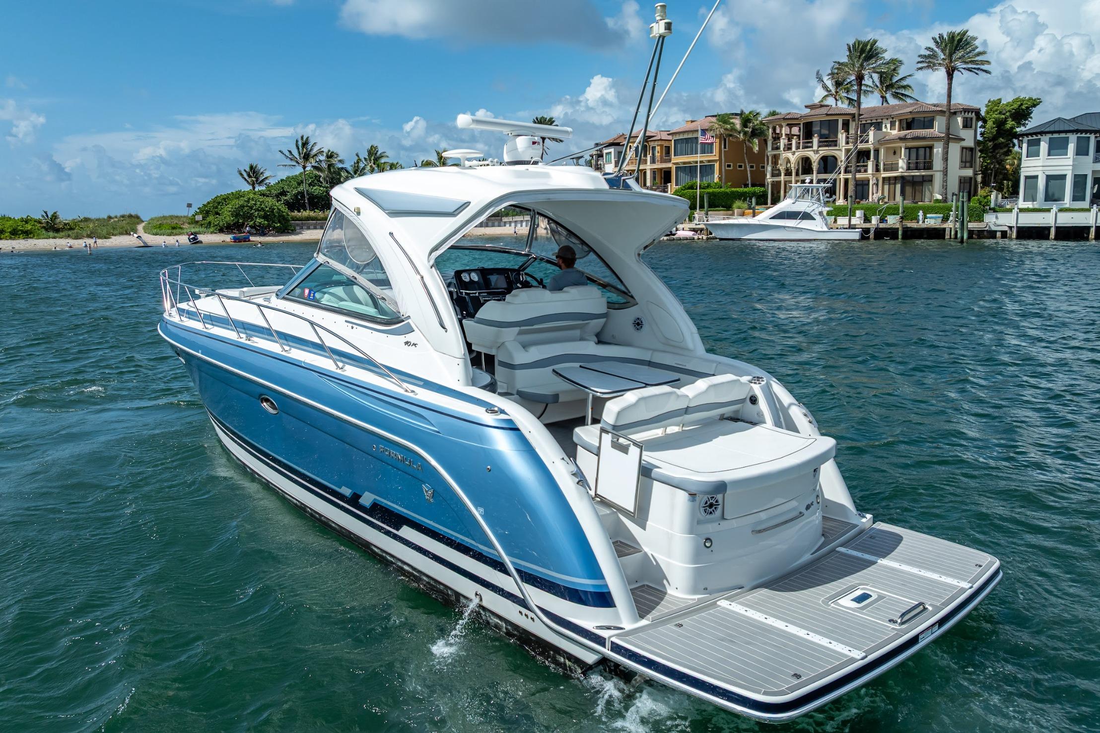 2022 Formula 40 Performance Cruiser on water near luxury waterfront homes.