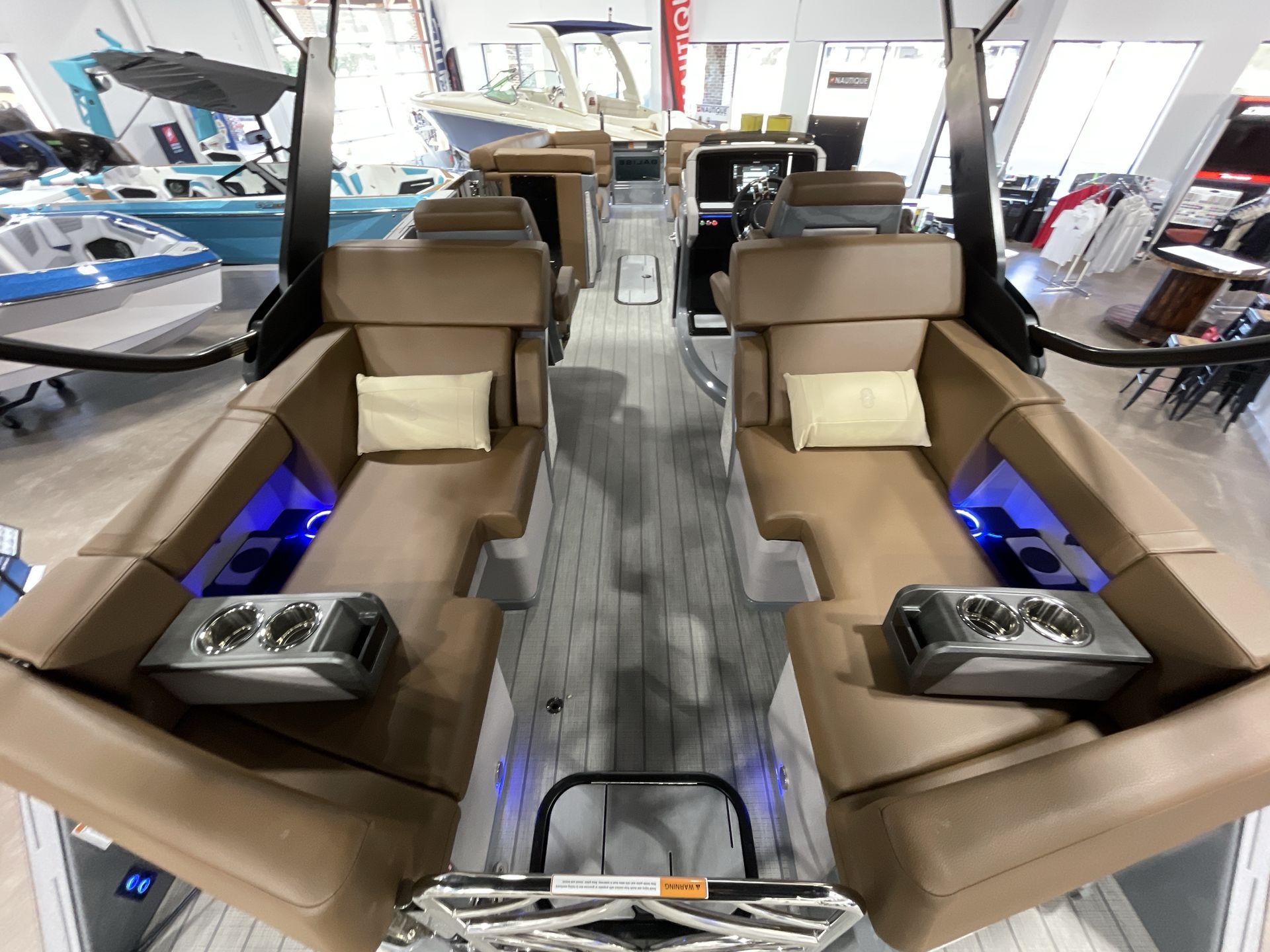 Luxurious interior of 2025 Balise Horizon 26C boat with plush seating and cup holders.