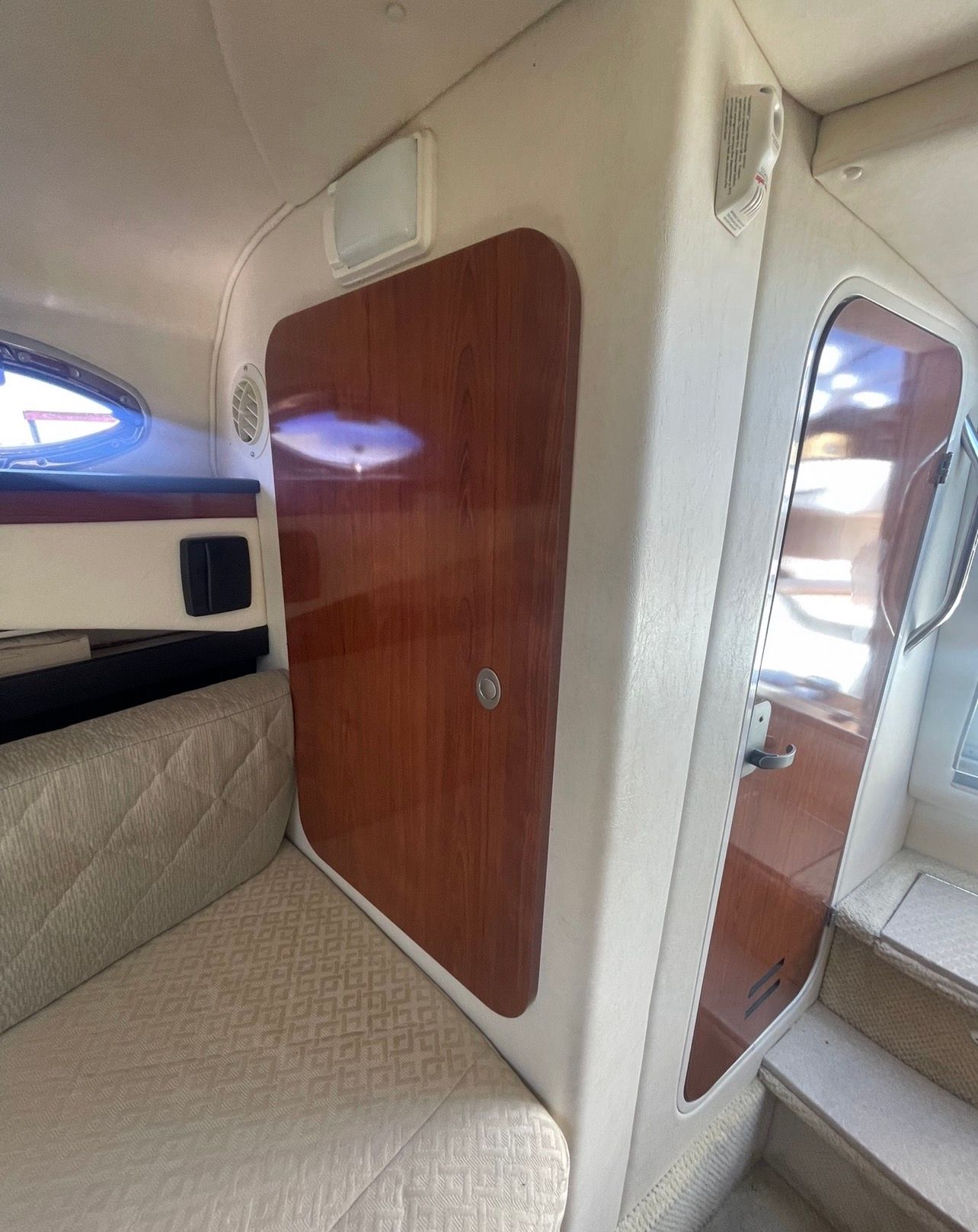 Interior of a 2006 Sea Ray 270 Amberjack with wooden doors.