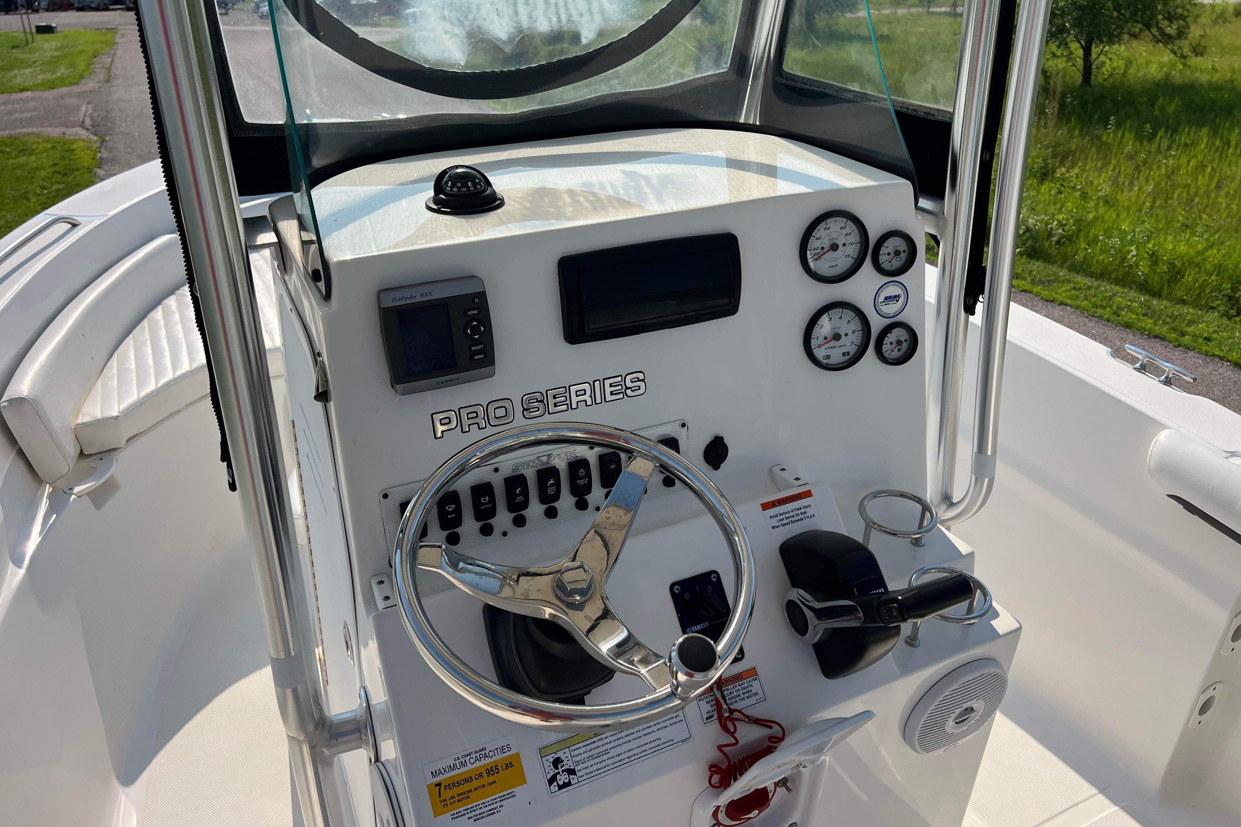 2012 Sea Fox 206 Center Console boat dashboard with steering wheel and gauges.