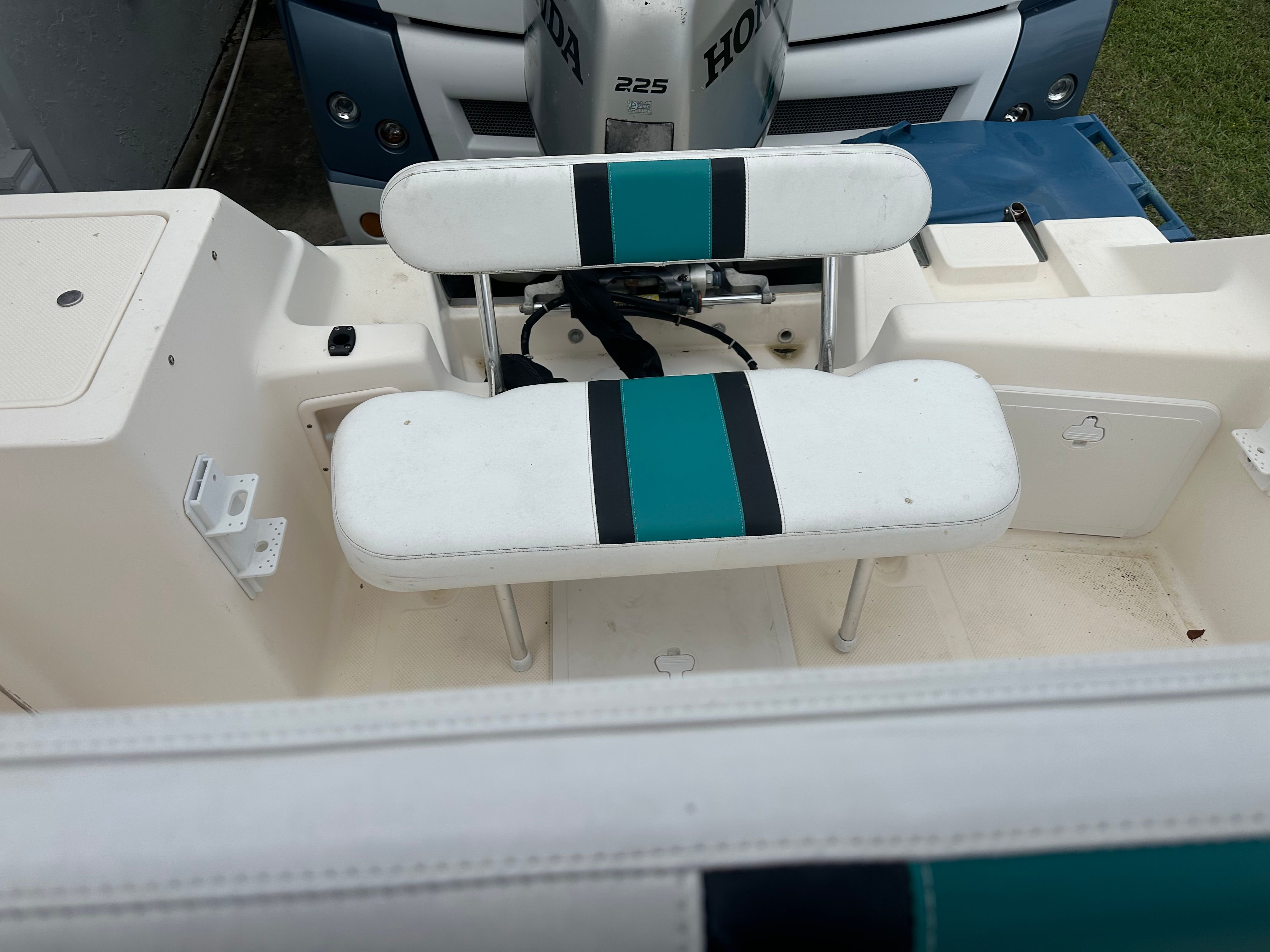 The bench seat on a 2004 Key West Blue Water 225cc boat is white with blue stripes.