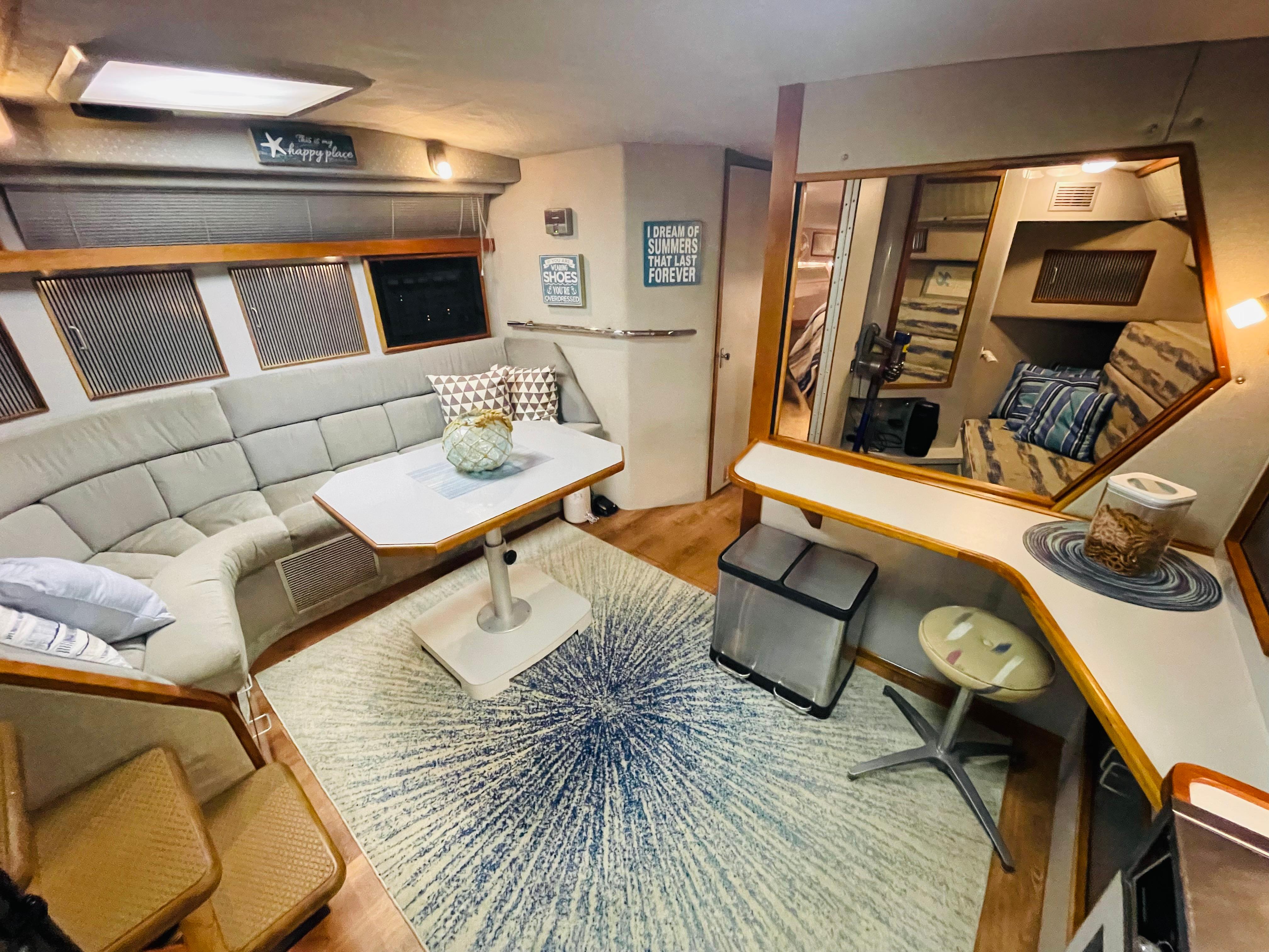 Interior of a 1989 Sea Ray 390 Express Cruiser with cozy seating area.