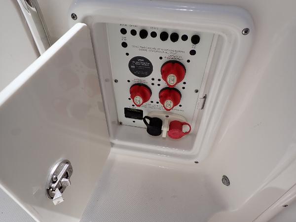 Electrical panel on 2011 Chaparral 287 SSX boat with red switches and white casing.