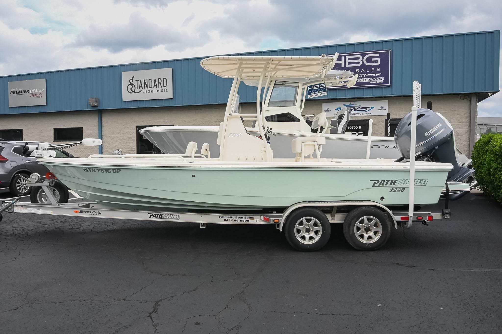 2021 Pathfinder 2200 TRS boat on trailer outside dealership.