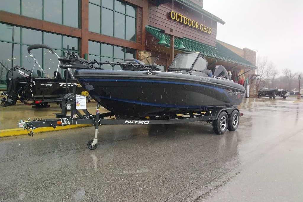 2026 Nitro ZV19 Sport Pro boat on trailer outside outdoor gear store.
