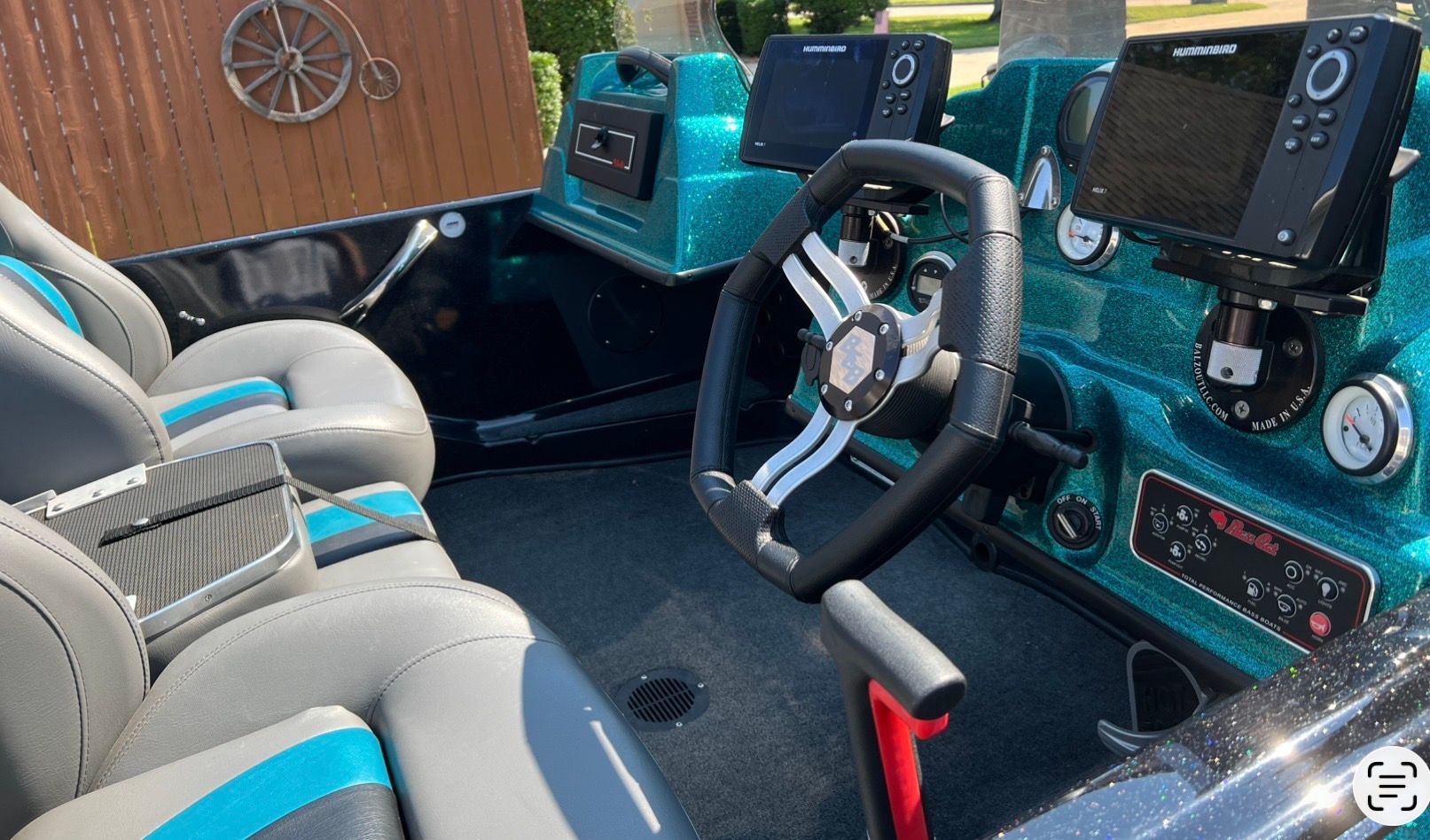 The image shows the cockpit of a 2020 Bass Cat Pantera II boat with modern instruments.