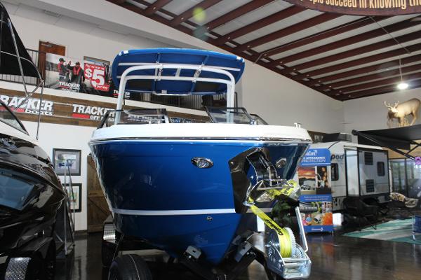 2025 Cobalt R6 boat displayed indoors, featuring a sleek blue design.