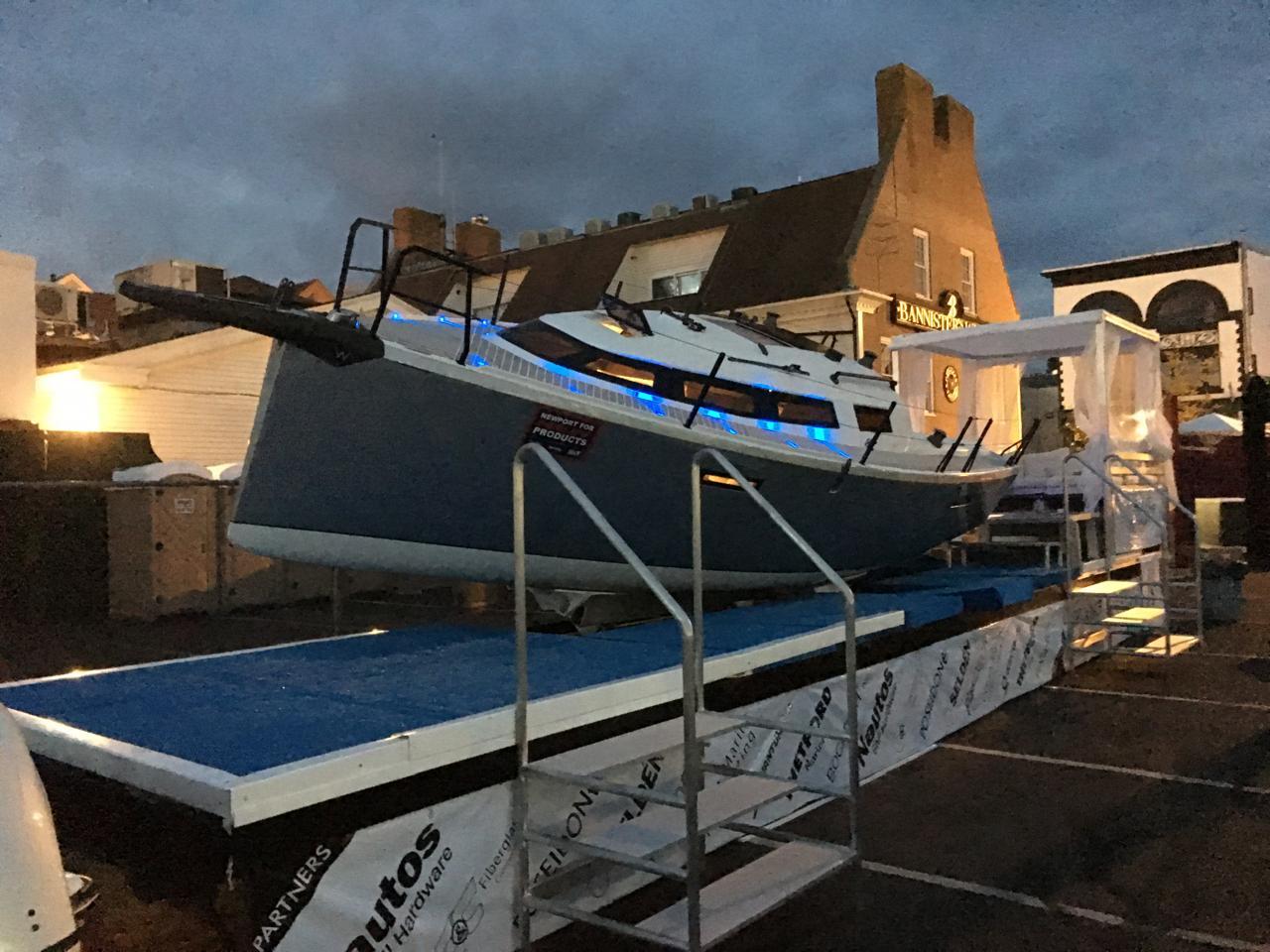 2025 Faro Yachts 29 displayed on a platform at dusk, with blue accent lighting.