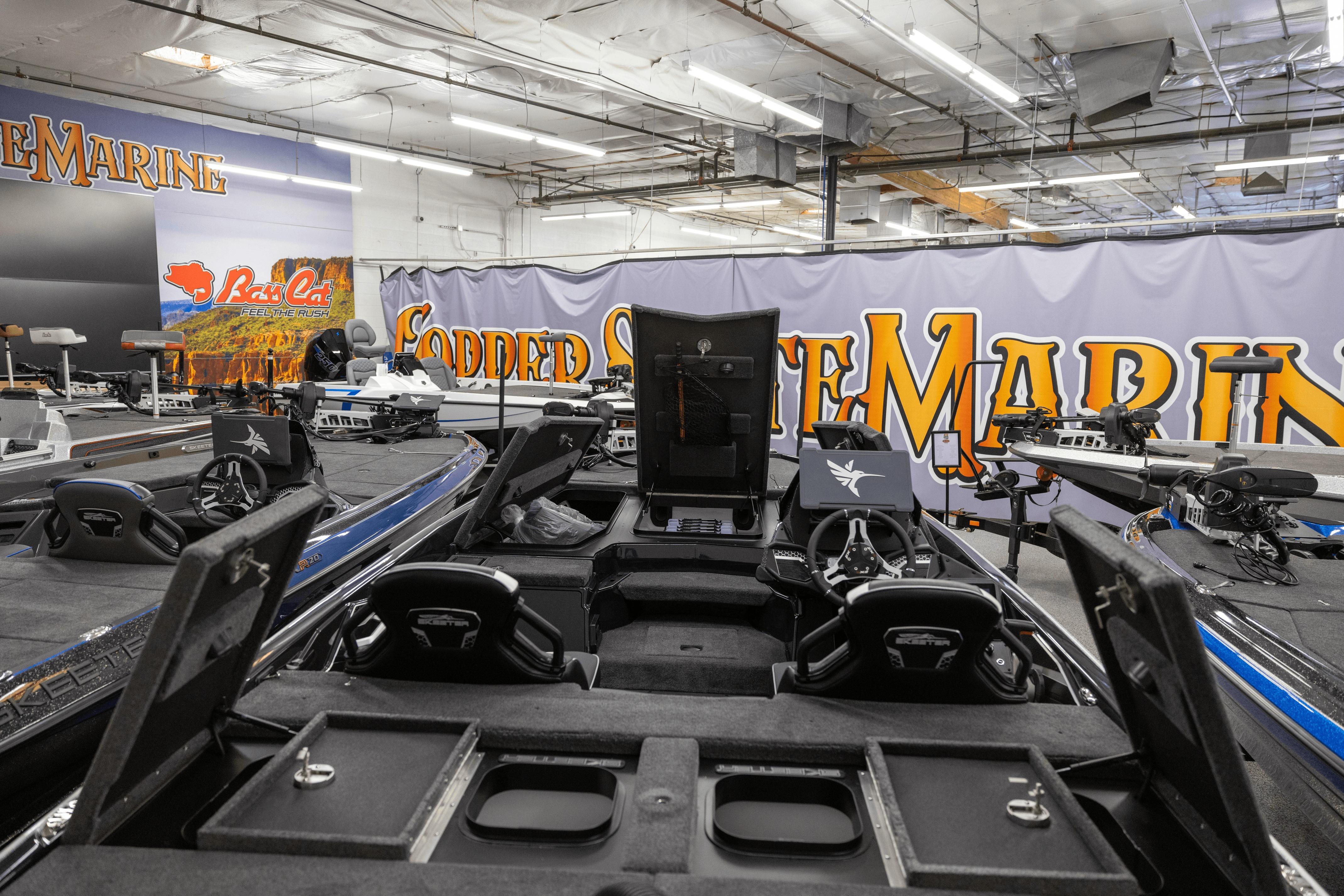 2026 Skeeter FXR21 FLEX boat displayed in a showroom with marine equipment.
