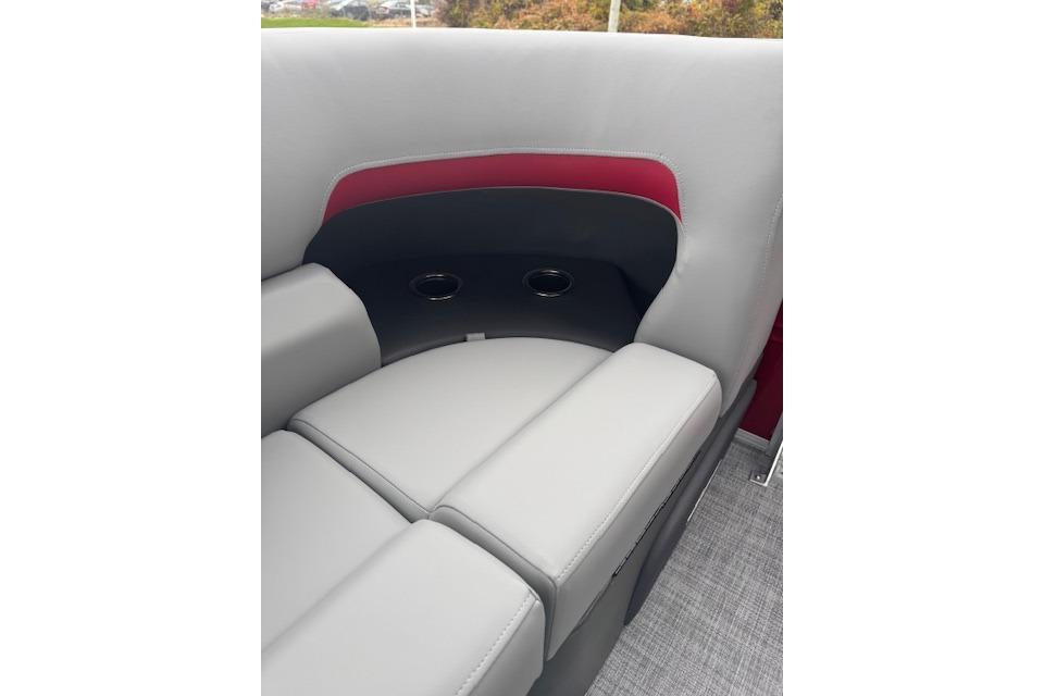 2026 Sun Tracker Party Barge 22 DLX interior seating with cup holders, gray and red upholstery.