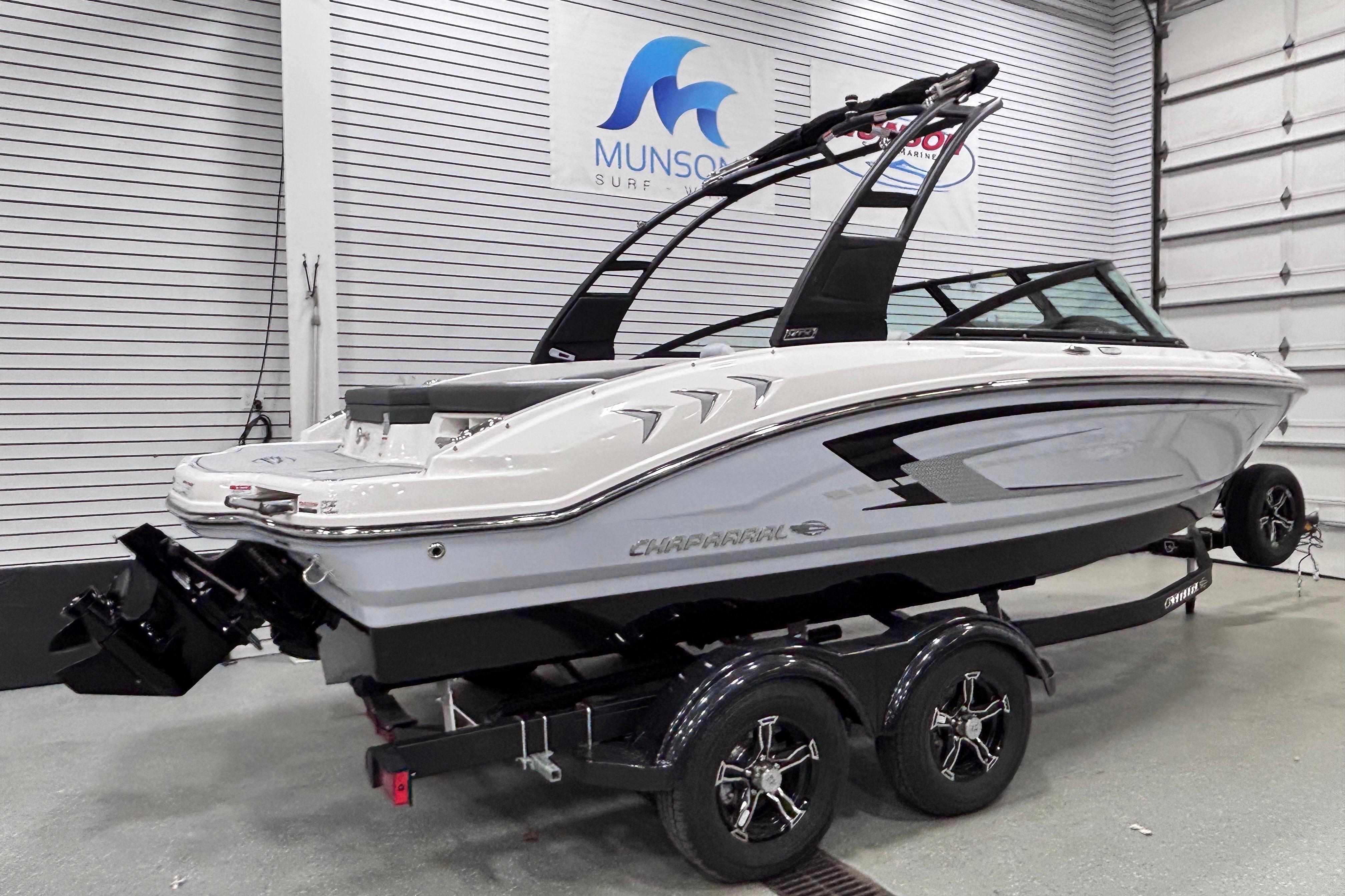2026 Chaparral 21 SSi boat on trailer in showroom, side view.