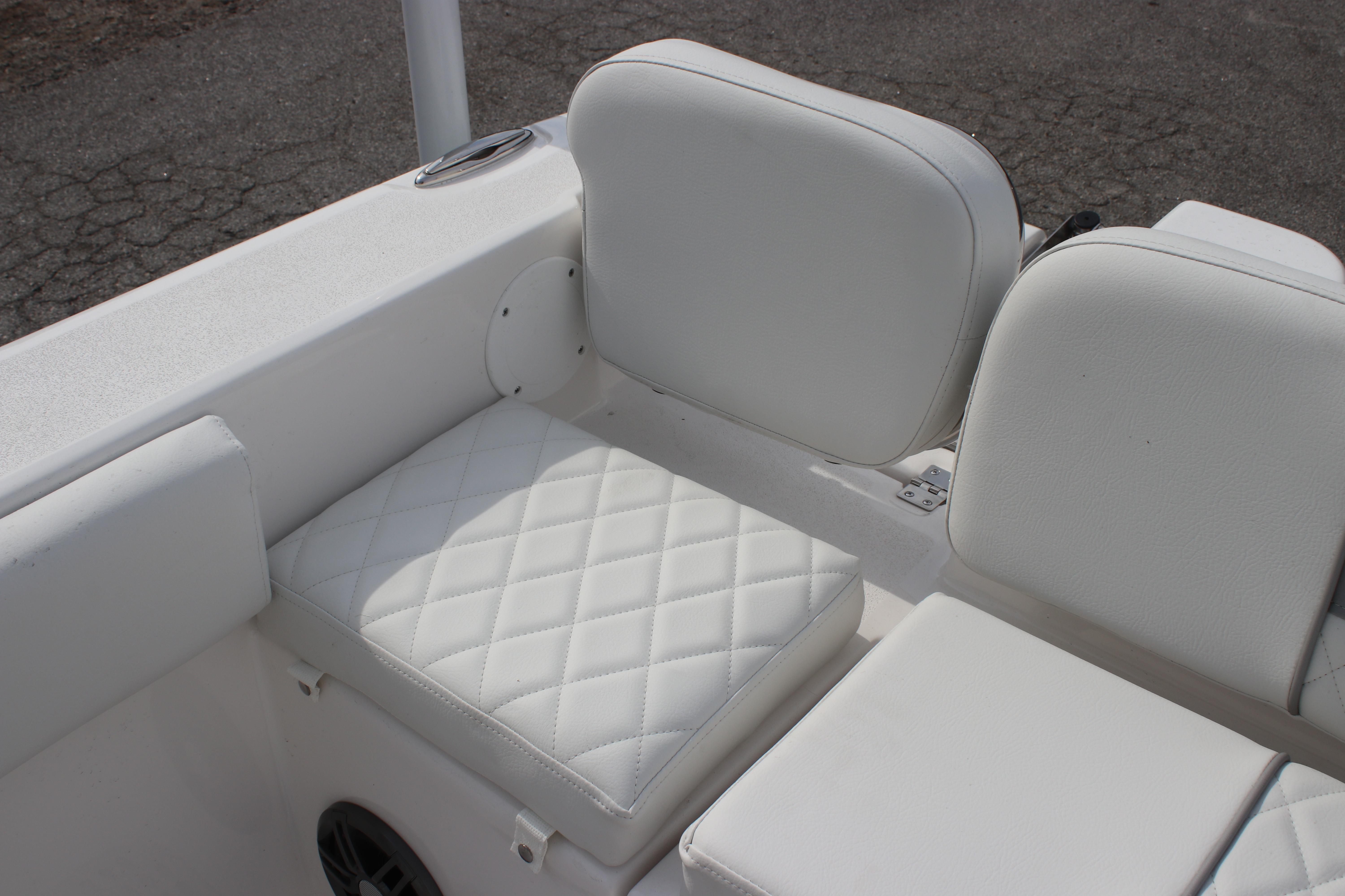 2026 Sea Fox 248 Commander boat seating with white cushioned upholstery.