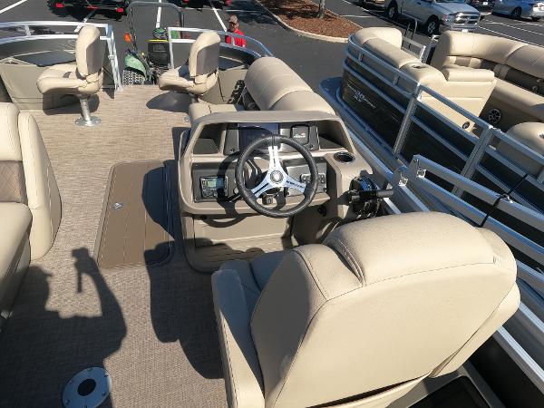 2024 Sun Tracker Fishin' Barge 22 XP3 interior with beige seating and steering console.