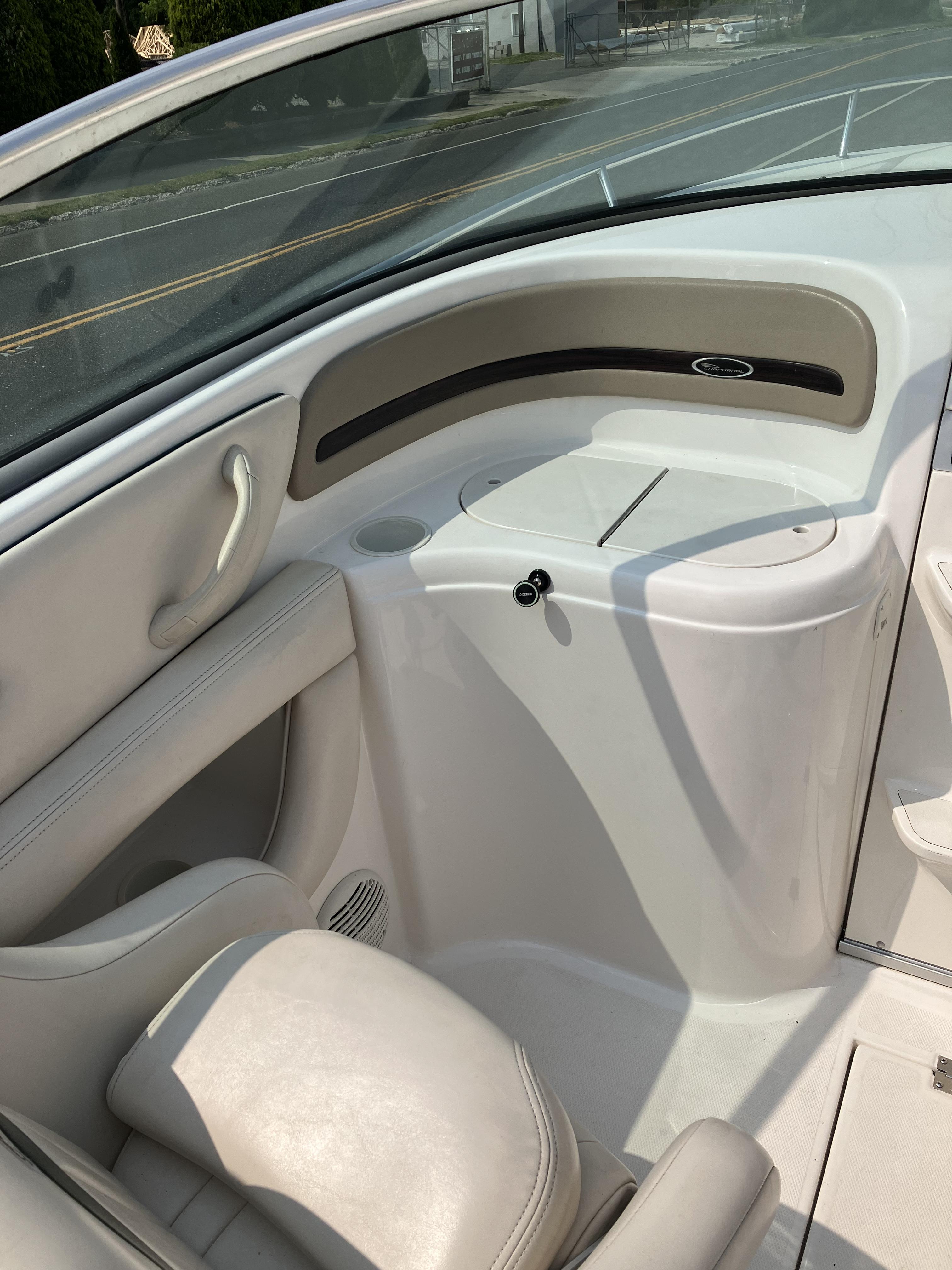 The image shows the cockpit of a 2001 Chaparral 235 SSi with beige seating.