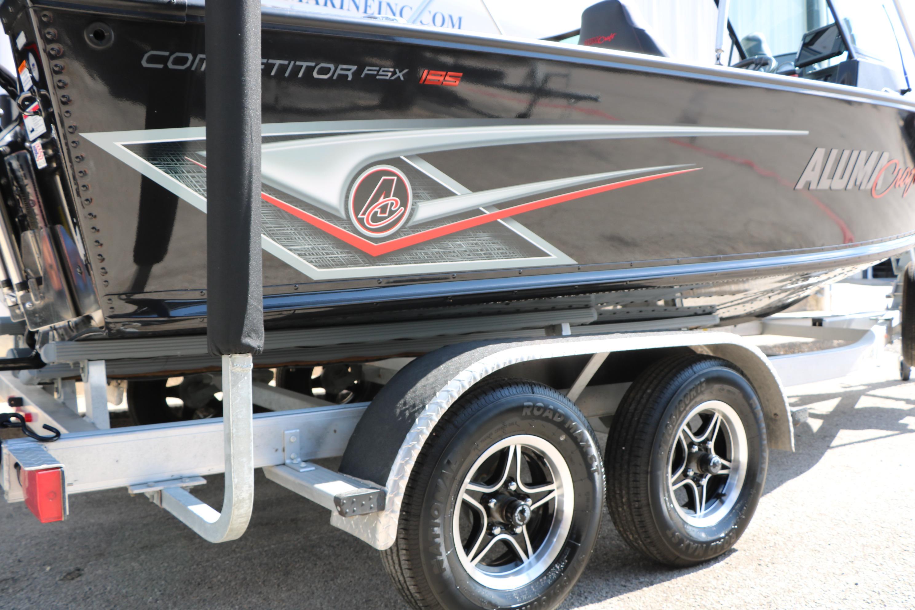 2023 Alumacraft Competitor FSX 185 boat on trailer, showcasing sleek design and graphics.