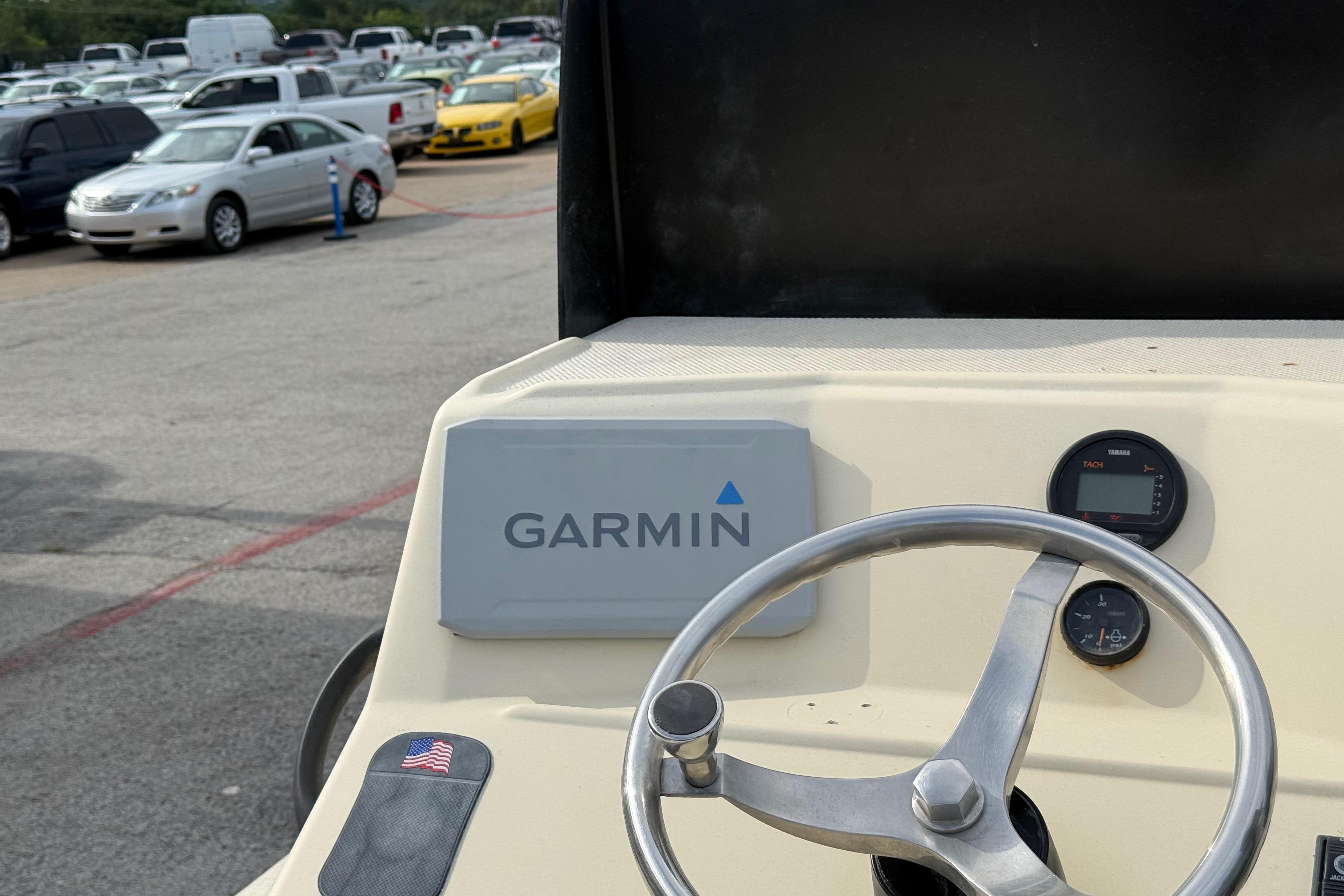 Steering wheel and Garmin device on 2007 Flats Cat 19 boat dashboard.