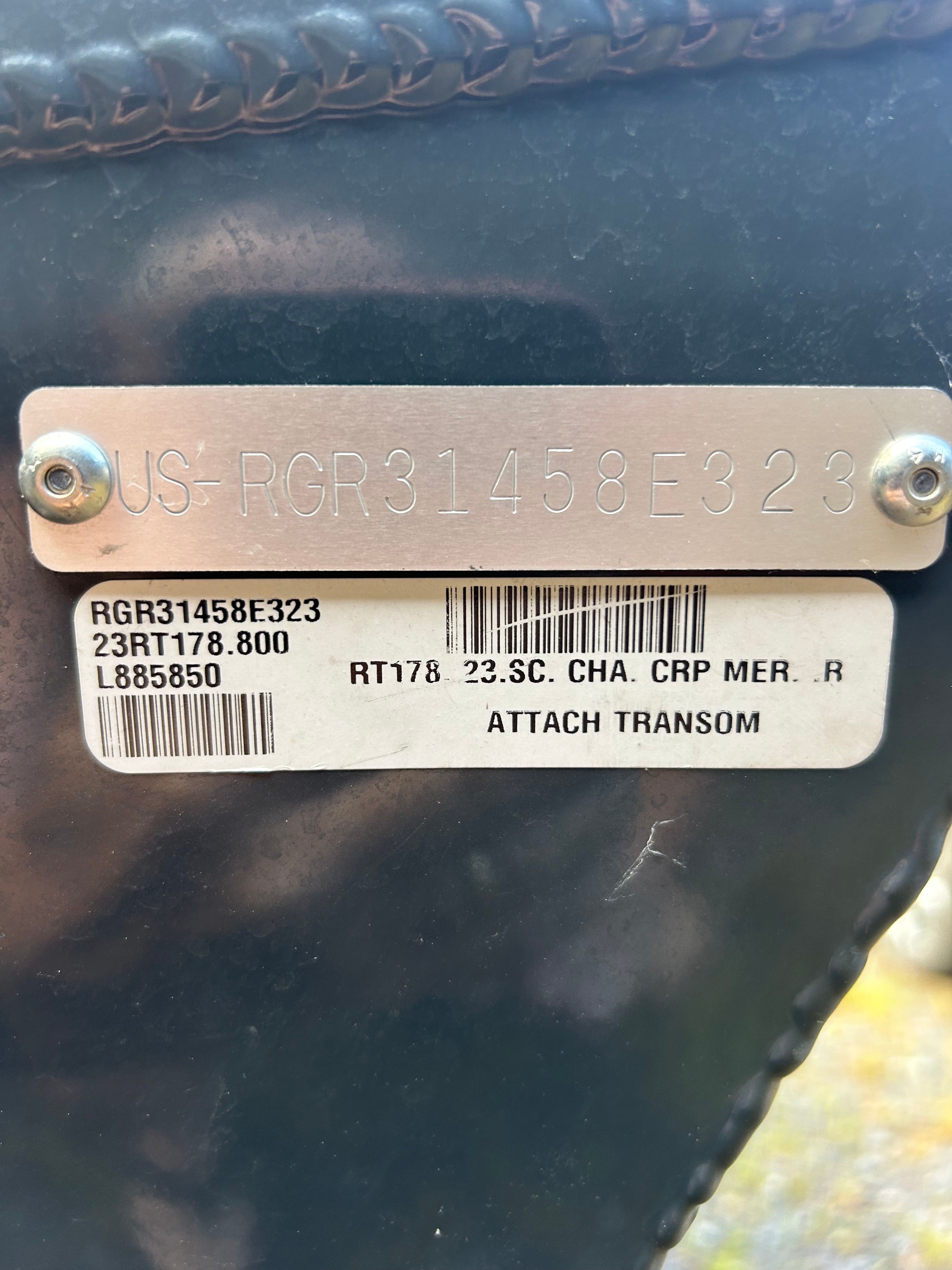 Close-up of a boat serial number plate with engraving and barcode.