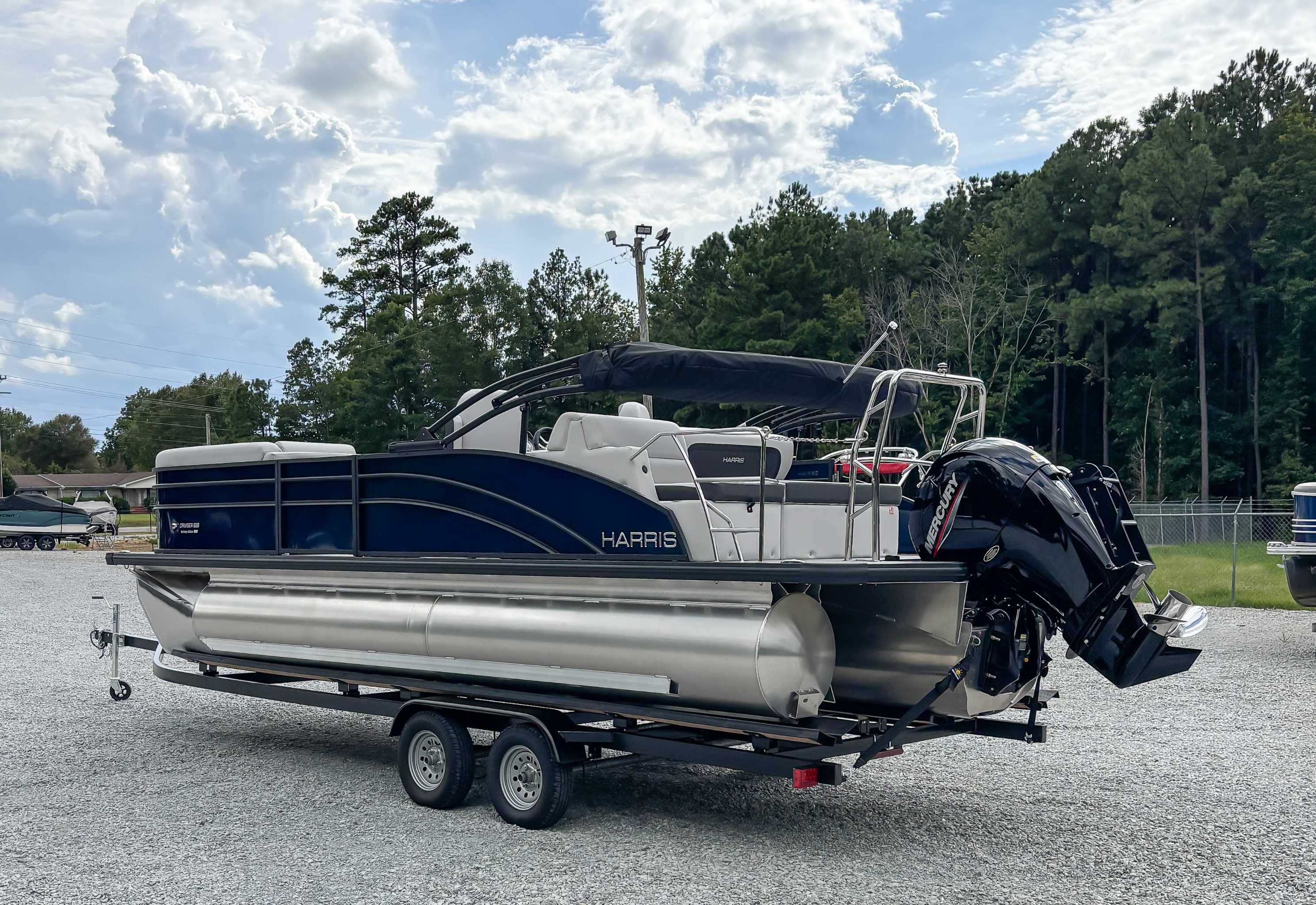 2026 Harris Cruiser 230 SLDH pontoon boat on trailer outdoors.