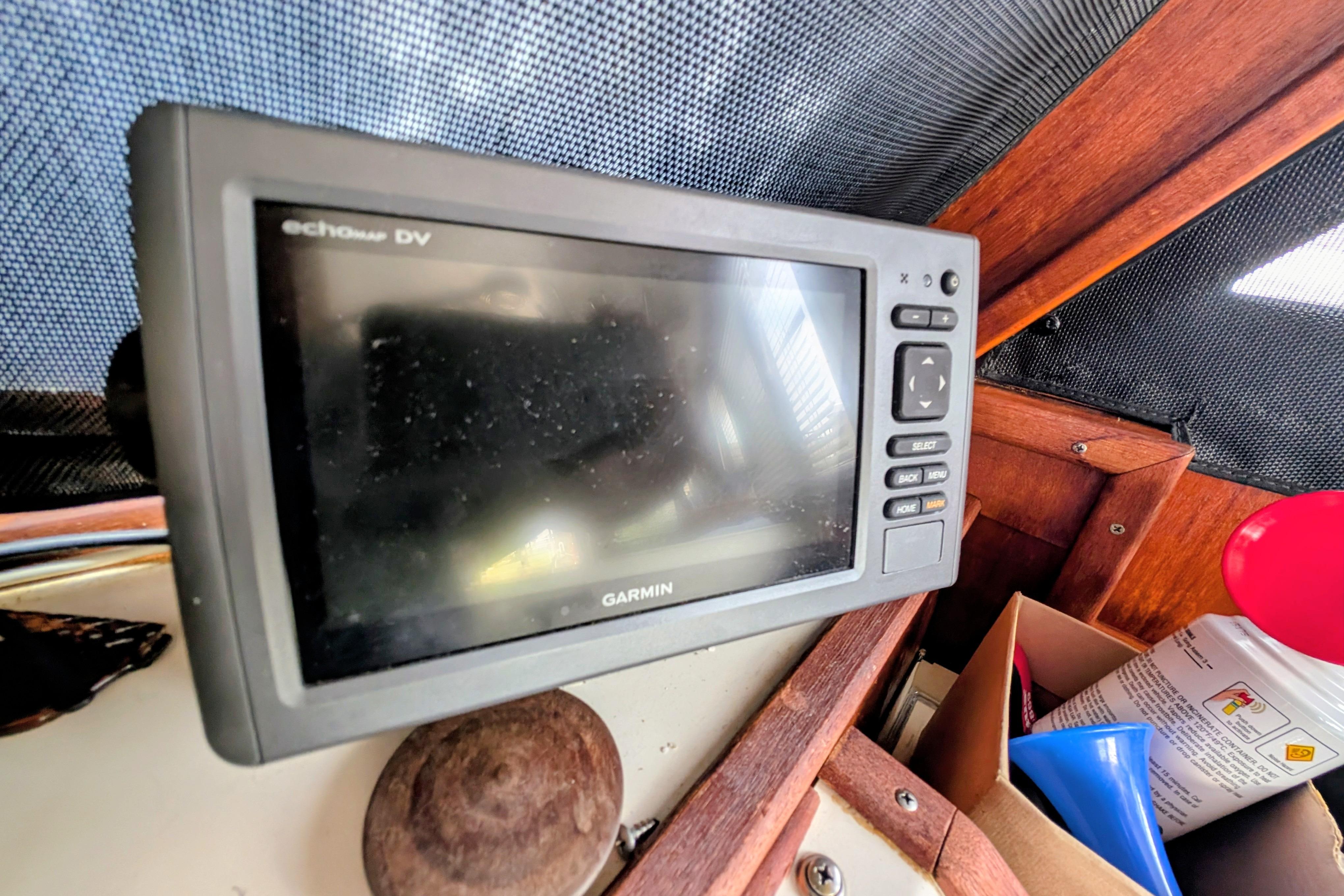 Garmin echoMAP DV on 1998 Markley 46 boat dashboard, surrounded by wooden paneling.