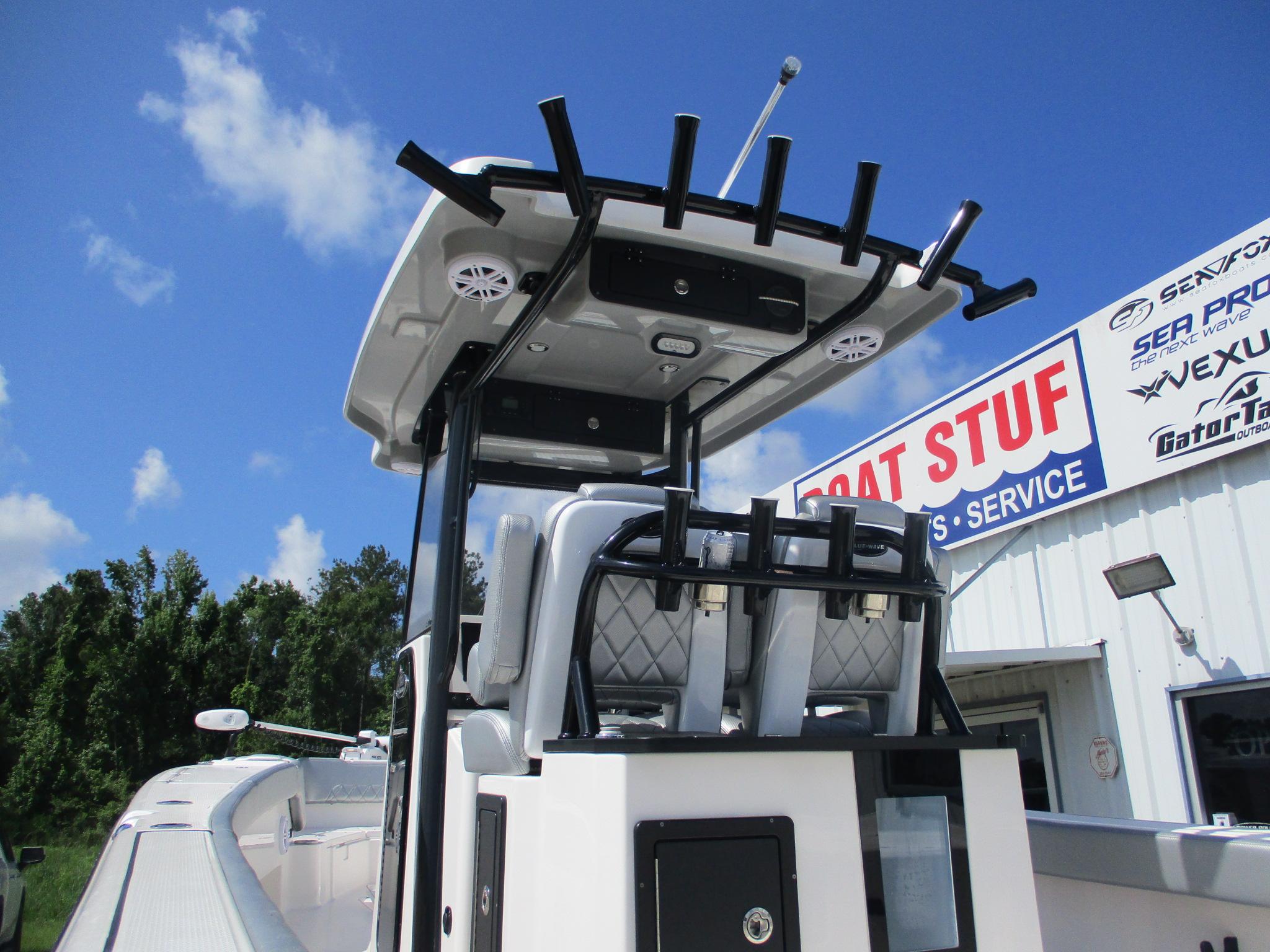 2024 Blue Wave 2800 Makaira boat at dealership, clear sky background.