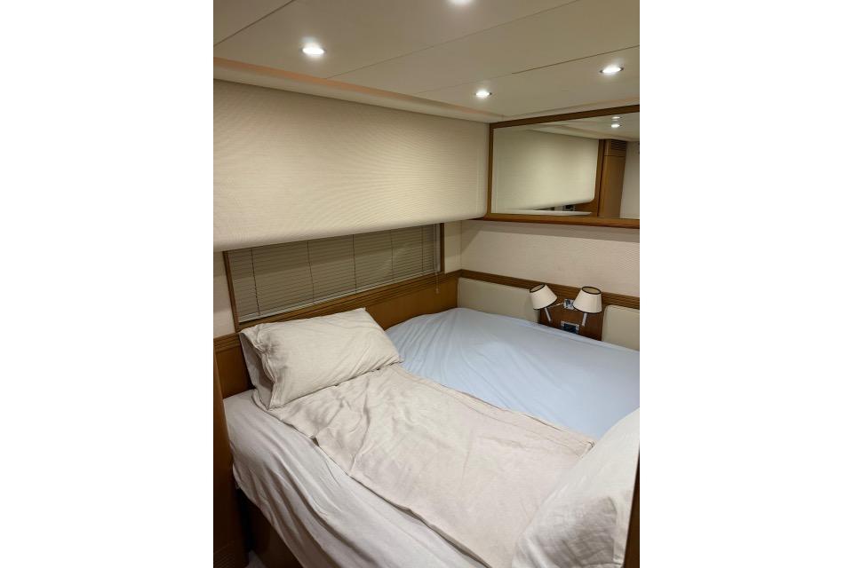 Luxurious bedroom interior of 2008 Apreamare Maestro 65 yacht with cozy bedding.
